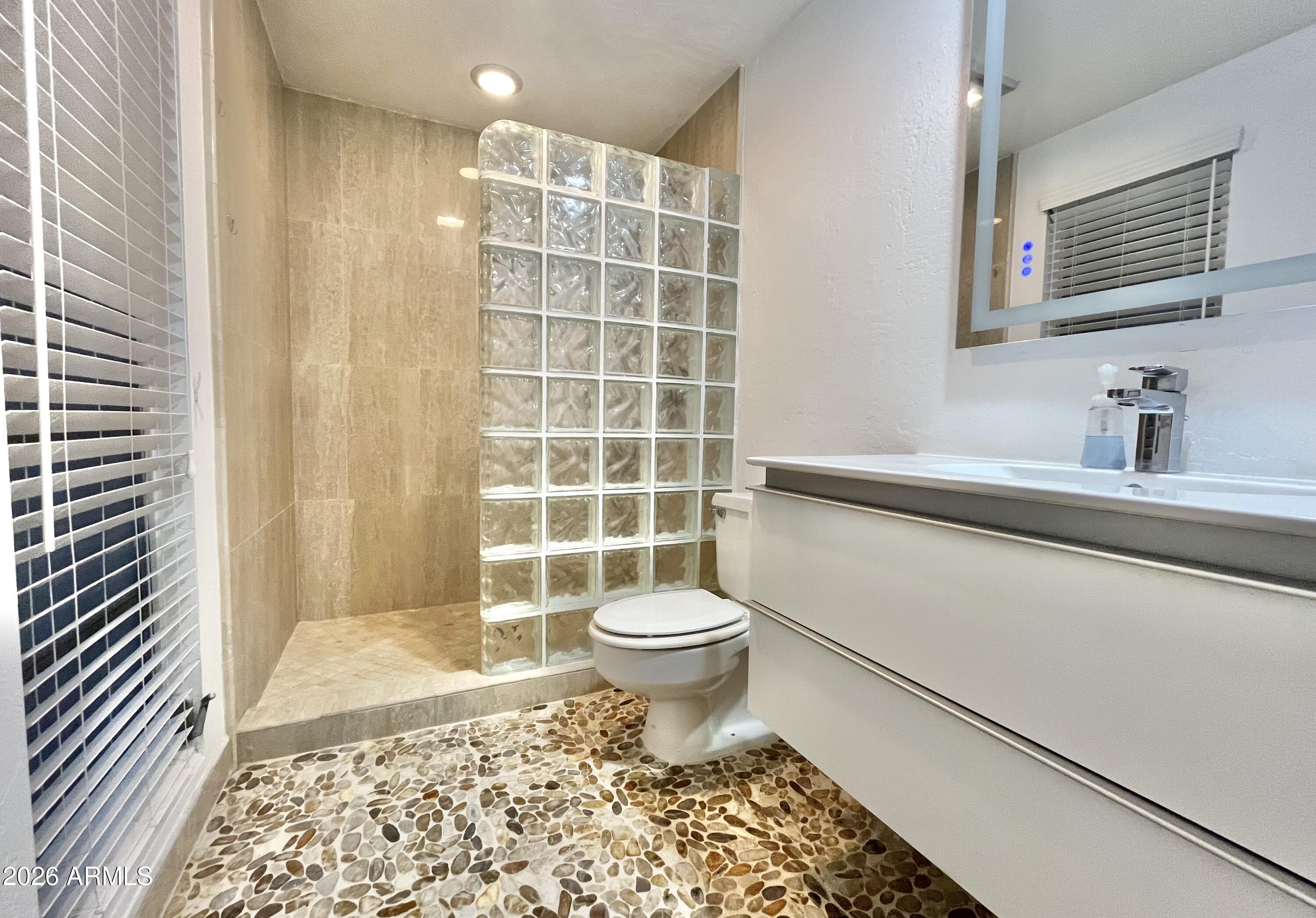 9718 West Oak Ridge Drive Sun City, AZ 85351 - Photo 15 of 41 a bathroom with a sink toilet and shower