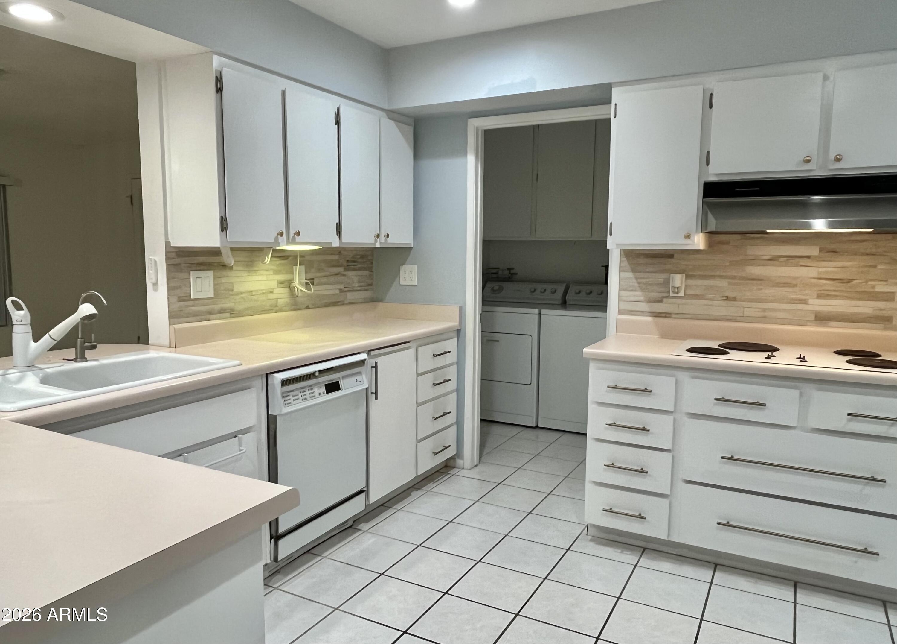 9718 West Oak Ridge Drive Sun City, AZ 85351 - Photo 28 of 41 a kitchen with cabinets appliances and a sink