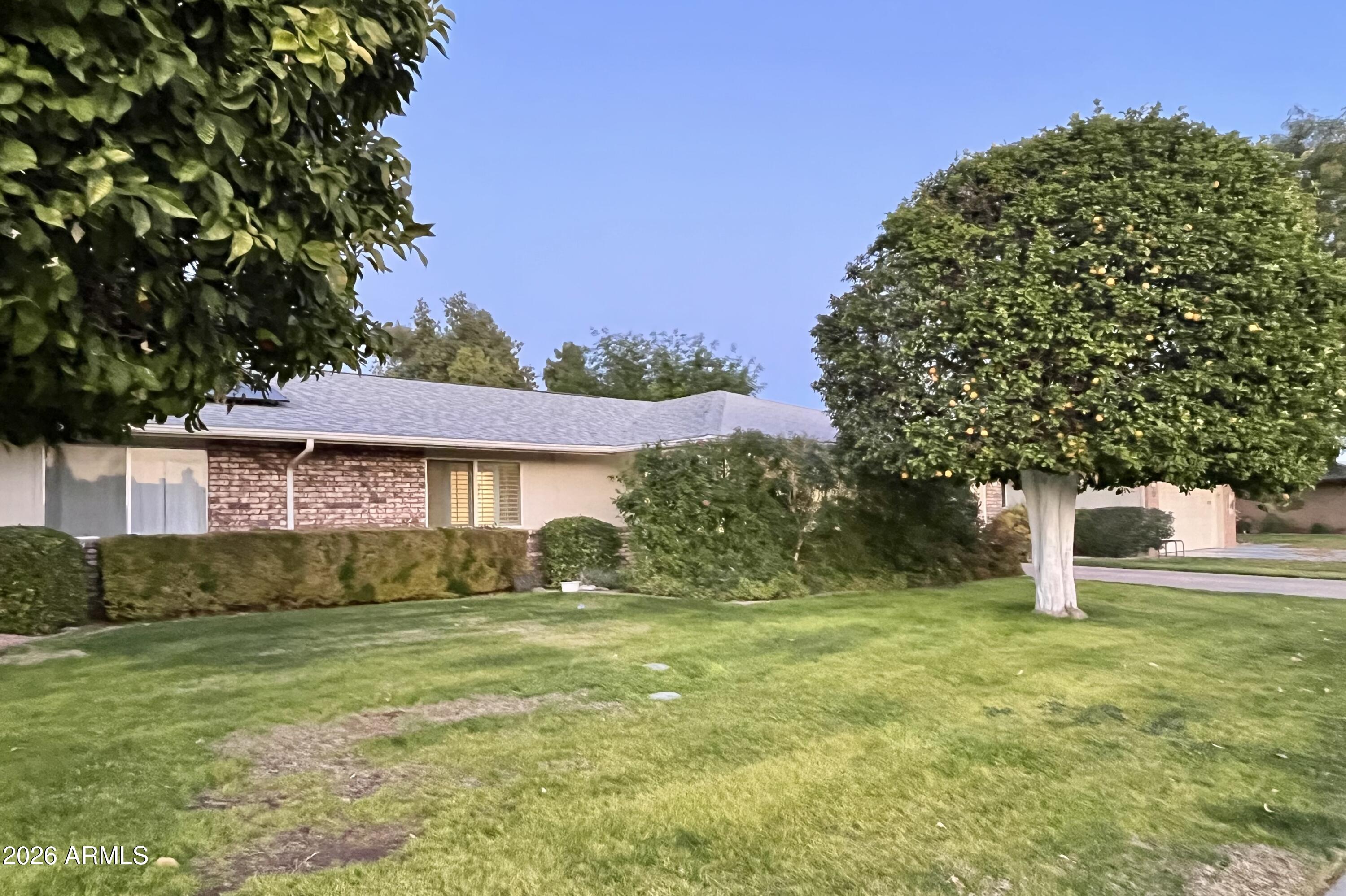 9718 West Oak Ridge Drive Sun City, AZ 85351 - Photo 34 of 41 a view of a house with a yard