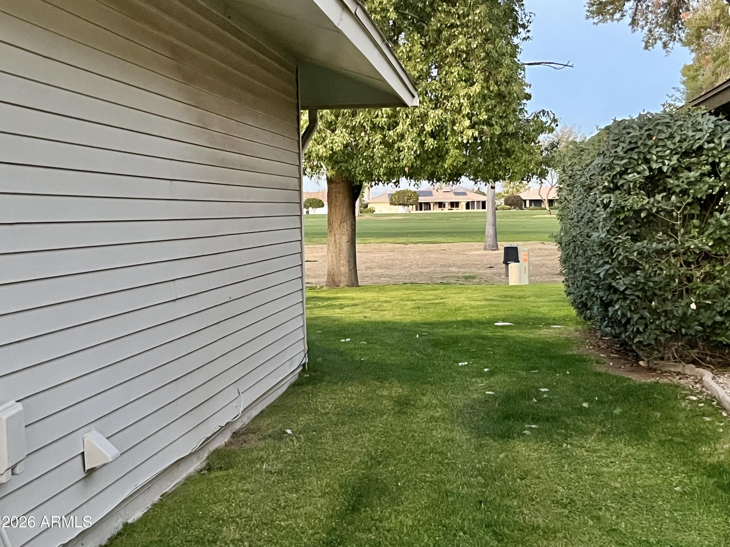 9718 West Oak Ridge Drive Sun City, AZ 85351 - Photo 36 of 41 a view of a backyard with a garden