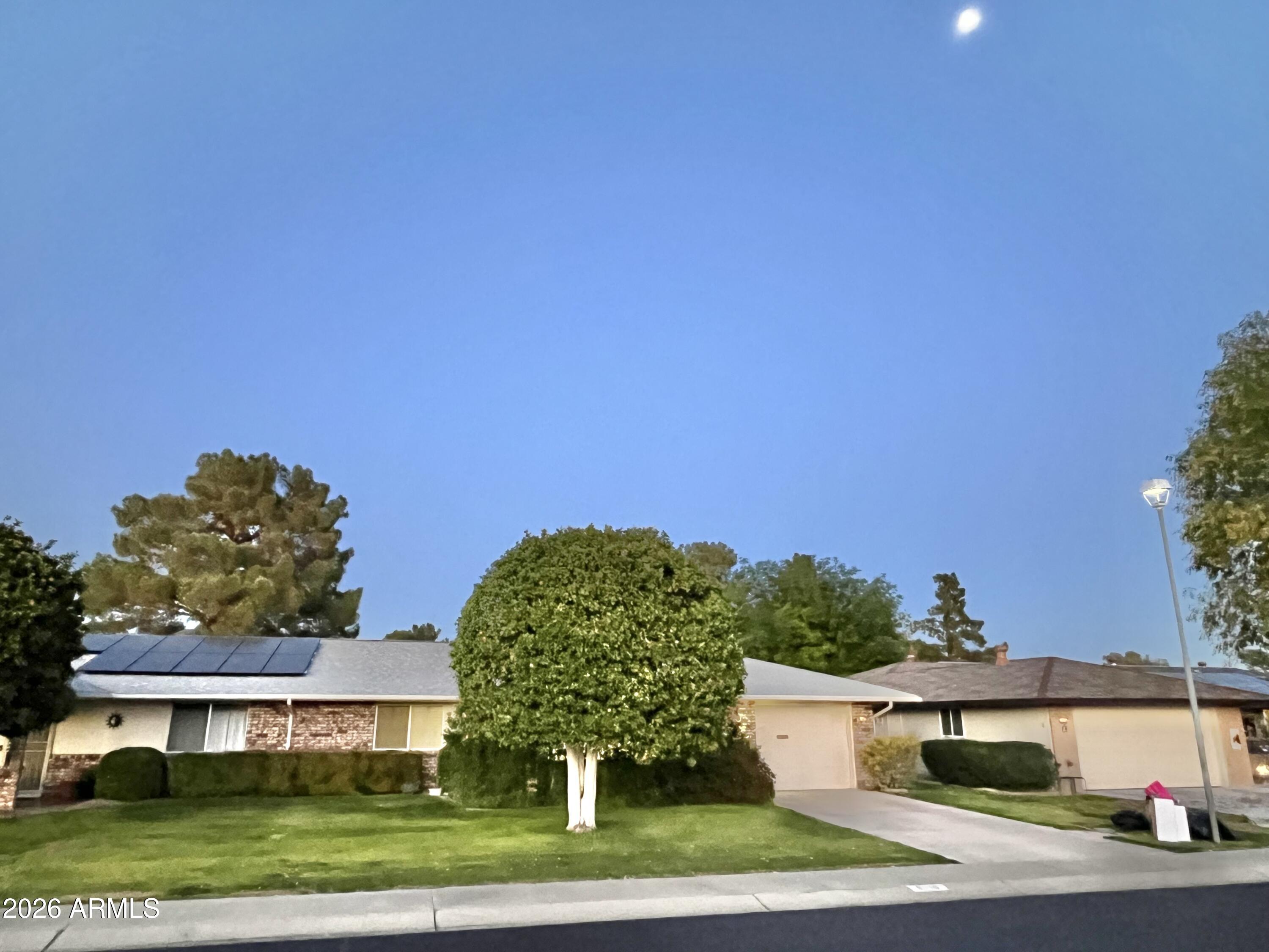 9718 West Oak Ridge Drive Sun City, AZ 85351 - Photo 41 of 41 a front view of a house with a yard