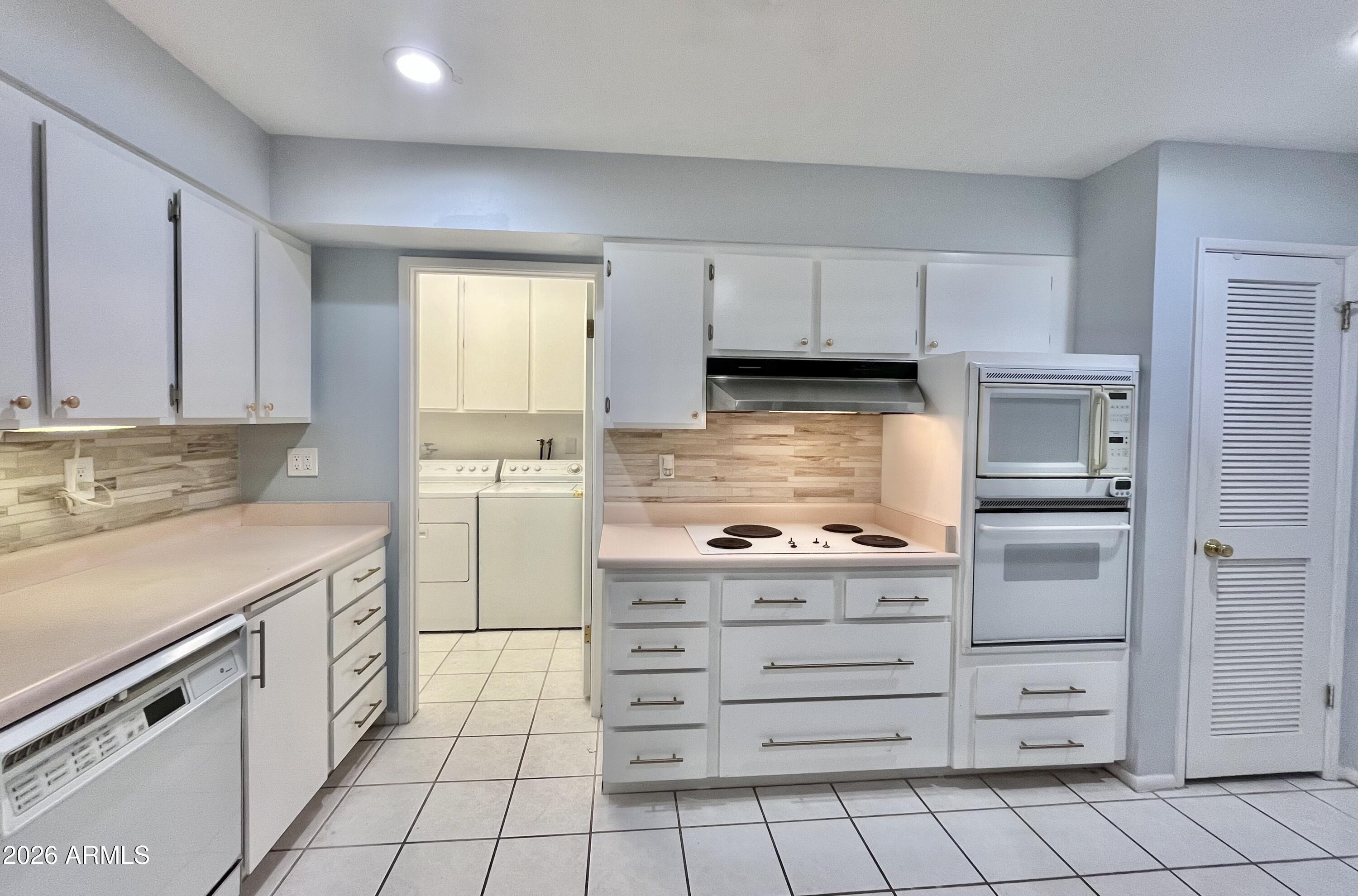 9718 West Oak Ridge Drive Sun City, AZ 85351 - Photo 8 of 41 a kitchen with cabinets appliances and a window