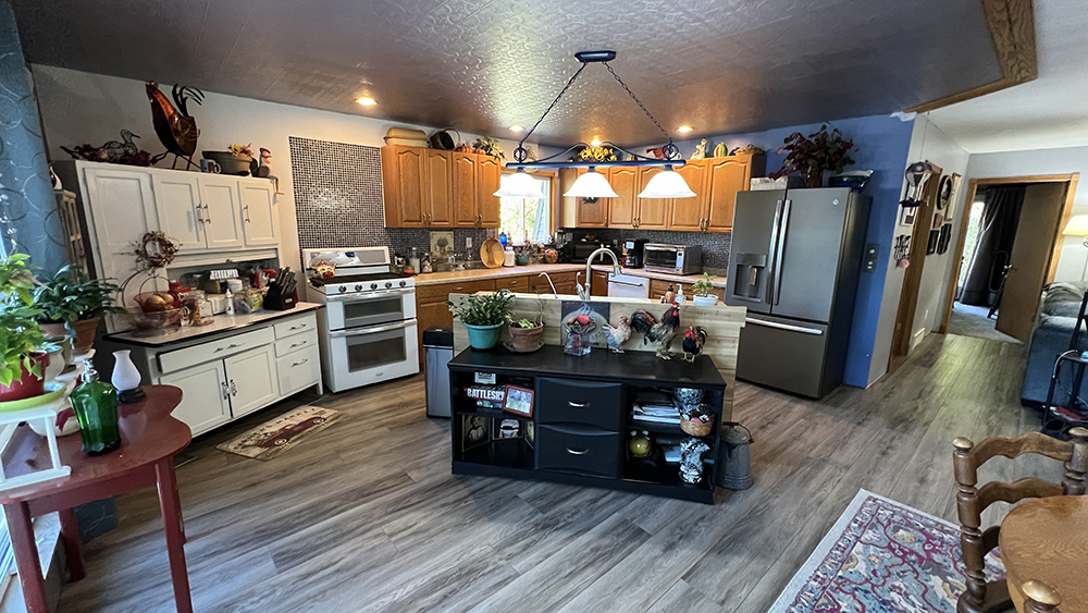 18510 Sand Road Fulton, IL 61252 - Photo 5 of 54 a kitchen with stainless steel appliances granite countertop a refrigerator a stove and a wooden floors