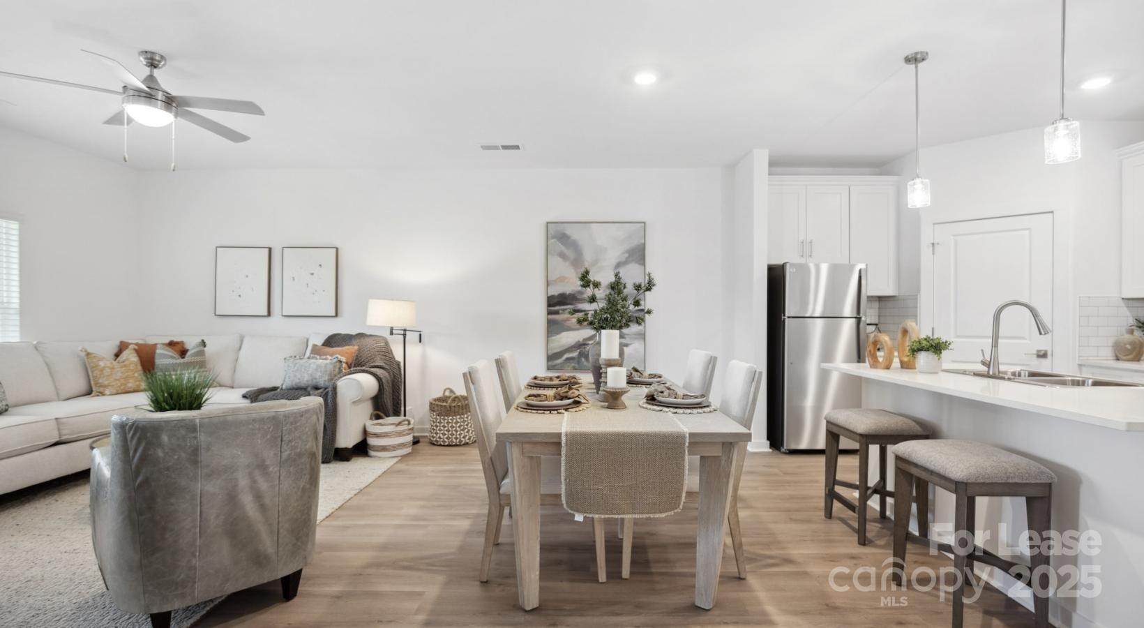 129 Blume Road, Unit MEANDER Mooresville, NC 28117 - Photo 16 of 32 a living room with furniture a chandelier and a dining table