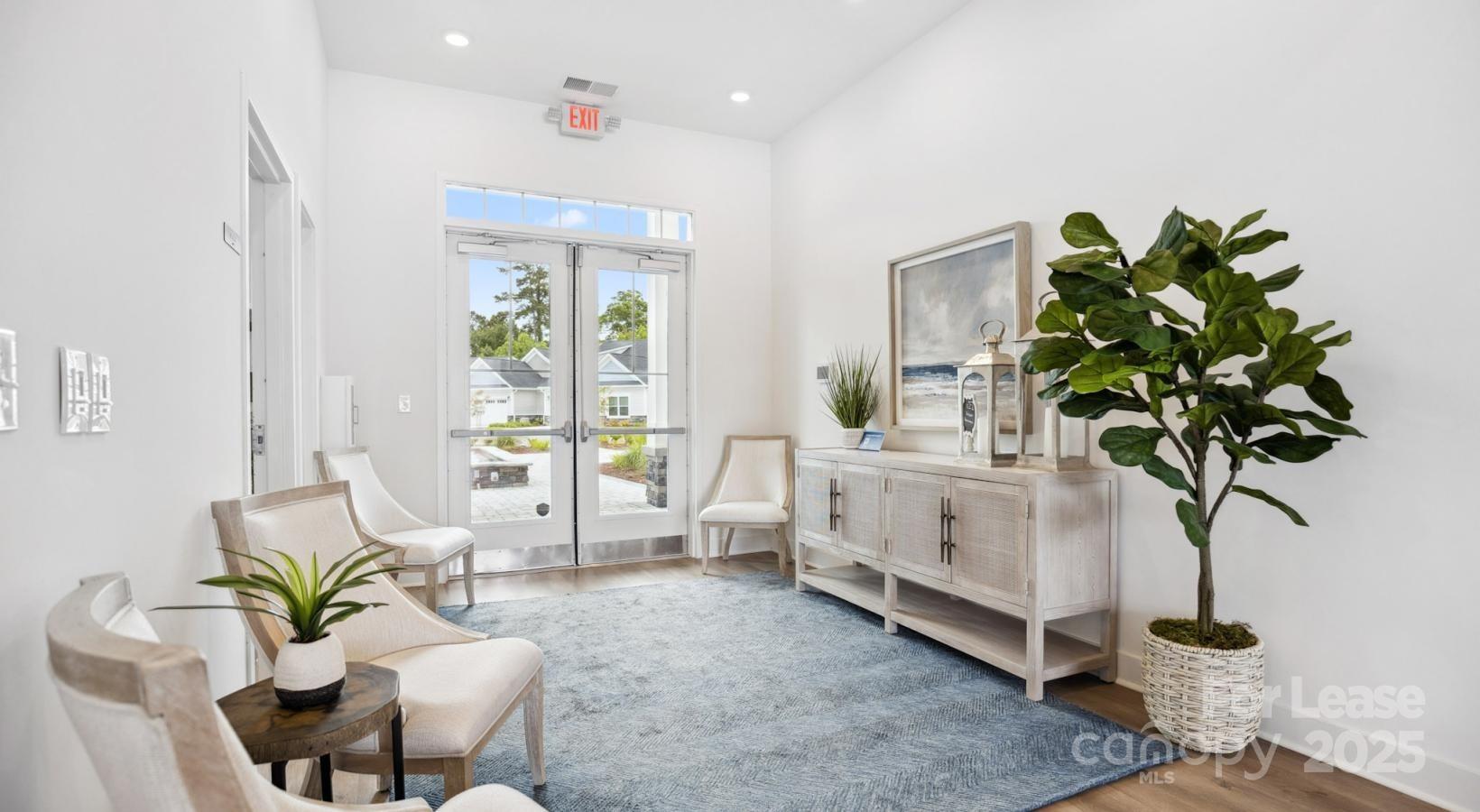 129 Blume Road, Unit MEANDER Mooresville, NC 28117 - Photo 20 of 32 a living room with furniture a chandelier and a potted plant