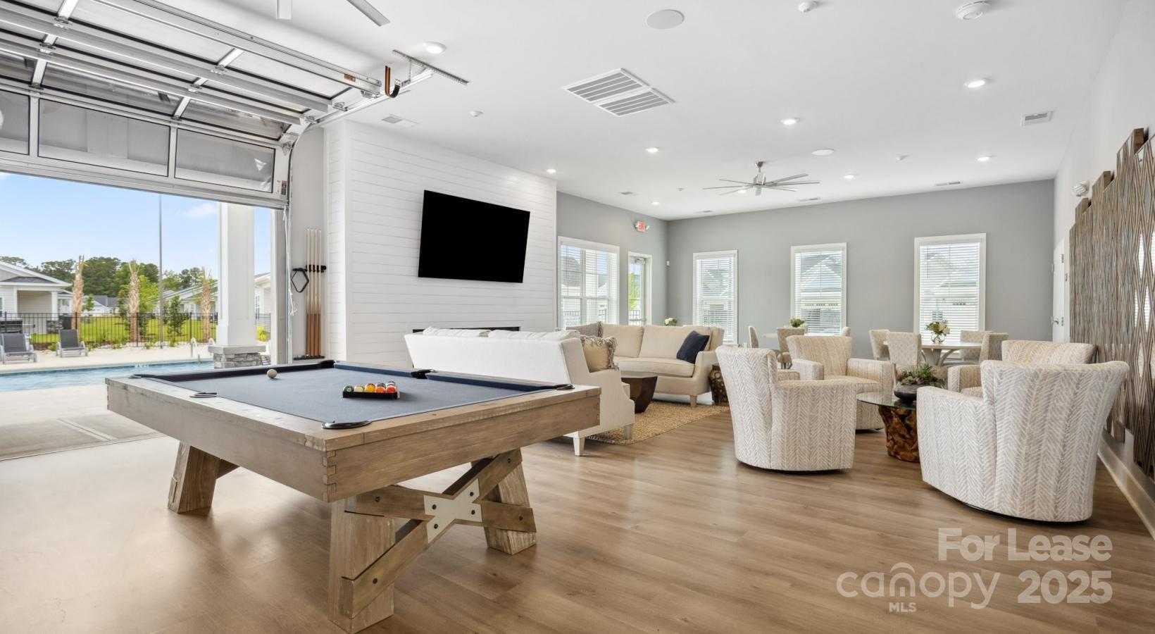 129 Blume Road, Unit MEANDER Mooresville, NC 28117 - Photo 27 of 32 a living room with dining table and a flat screen tv