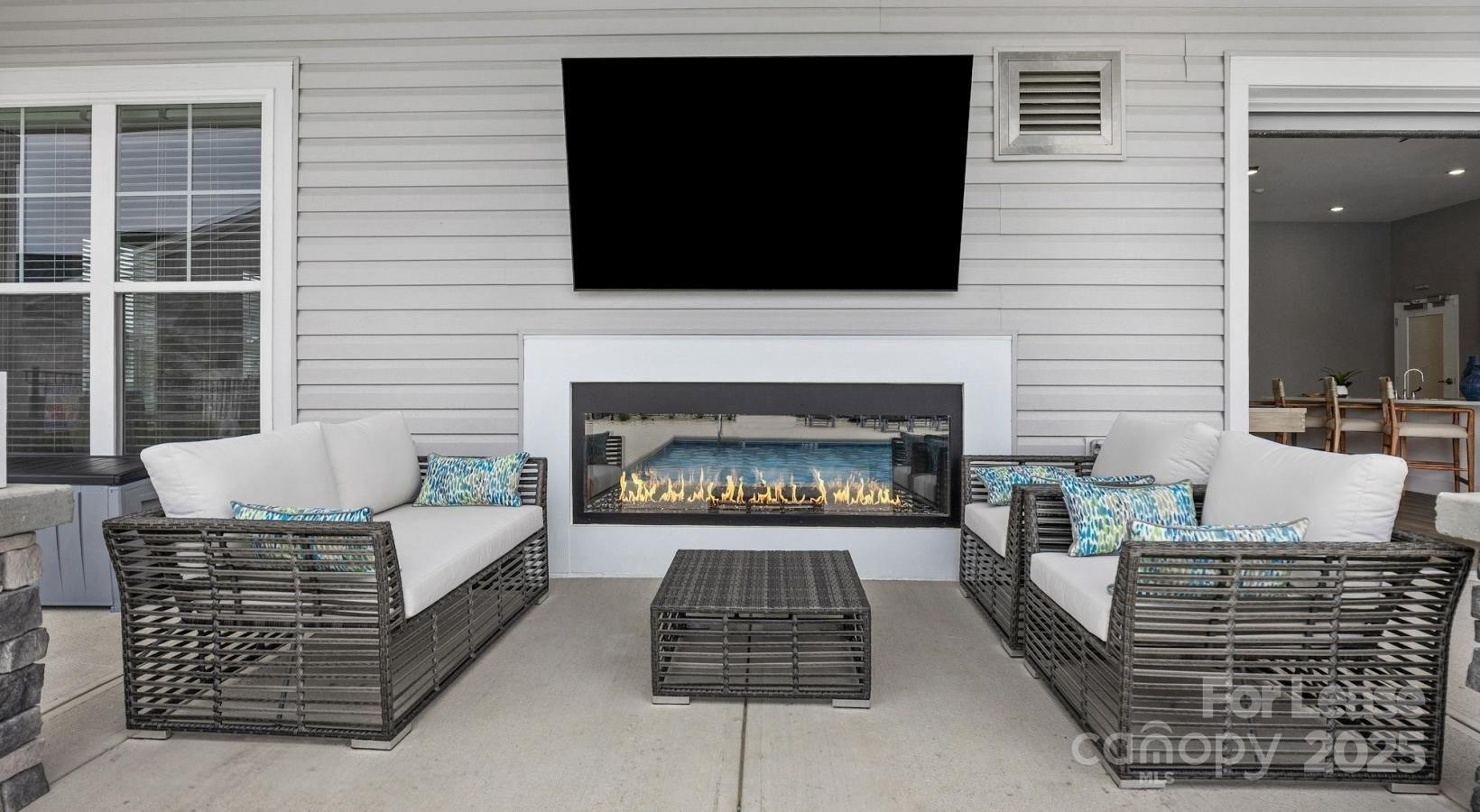 129 Blume Road, Unit MEANDER Mooresville, NC 28117 - Photo 30 of 32 a living room with furniture a flat screen tv and a fireplace