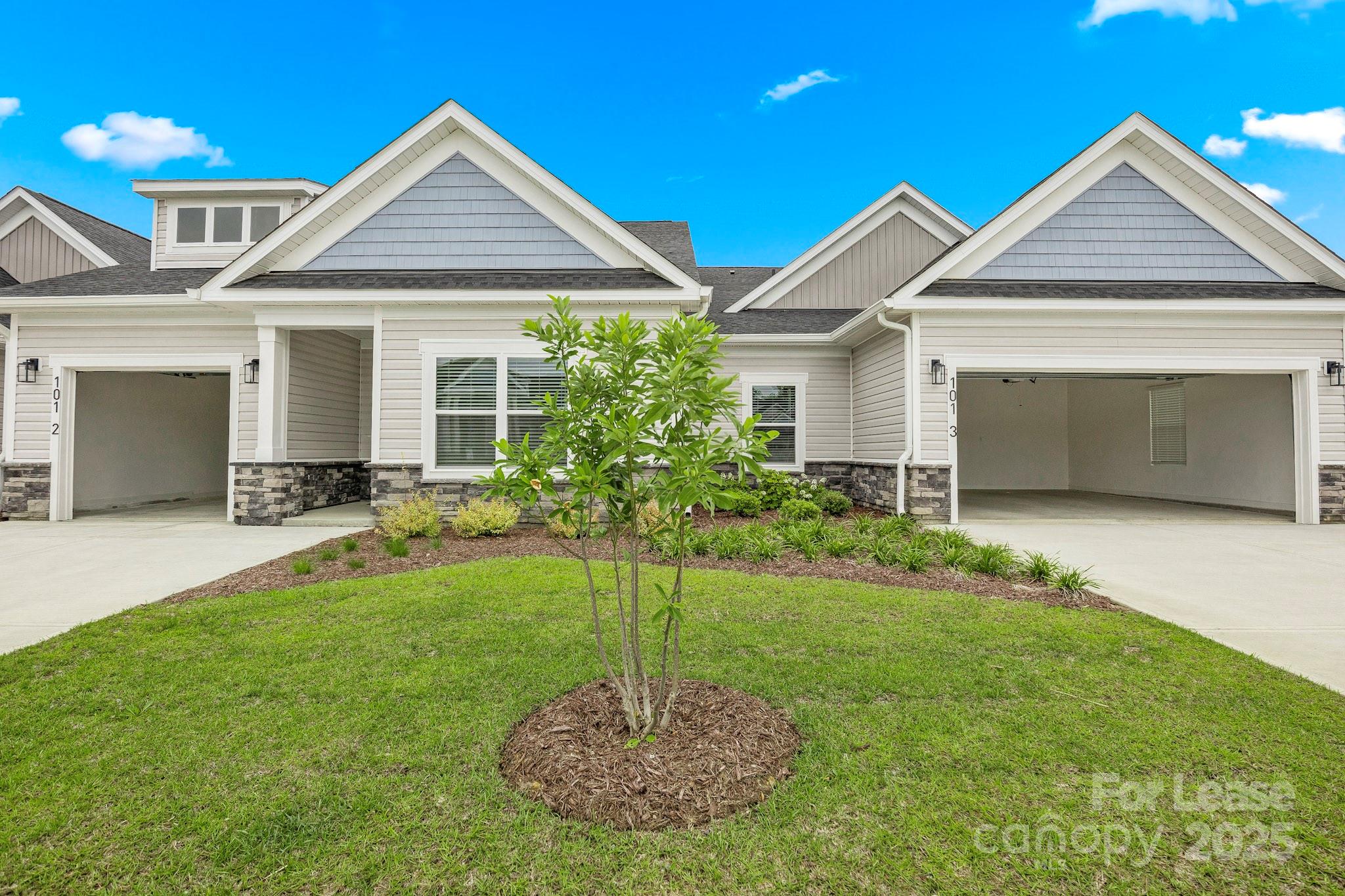 129 Blume Road, Unit MEANDER Mooresville, NC 28117 - Photo 3 of 32 a front view of a house with a yard and garage