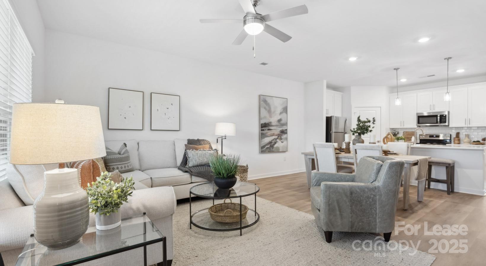 129 Blume Road, Unit MEANDER Mooresville, NC 28117 - Photo 5 of 32 a living room with furniture kitchen view and a potted plant