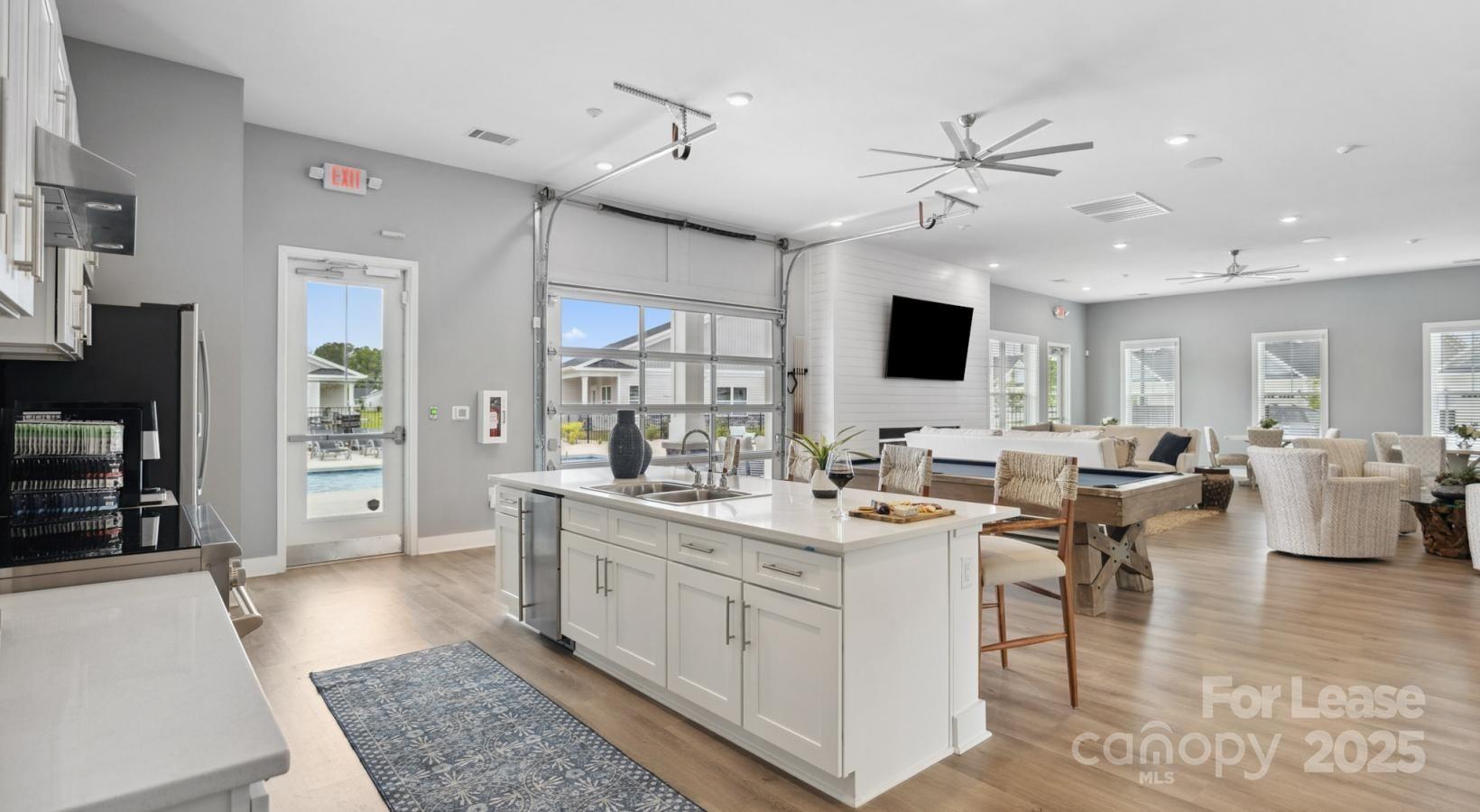 129 Blume Road, Unit MEANDER Mooresville, NC 28117 - Photo 6 of 32 a living room with stainless steel appliances furniture a rug and a view