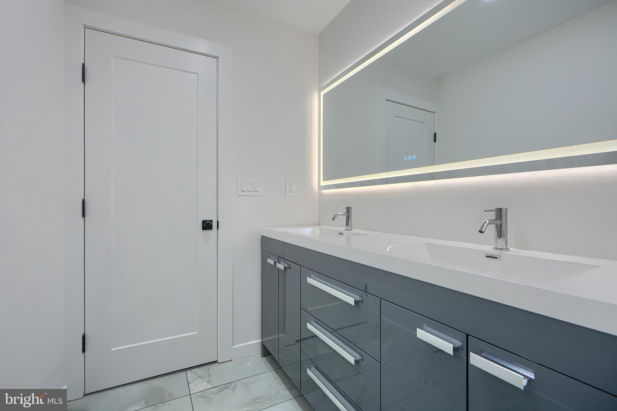 3410 Pinkney Road Baltimore, MD 21215 - Photo 33 of 55 a bathroom with a double vanity sink and mirror