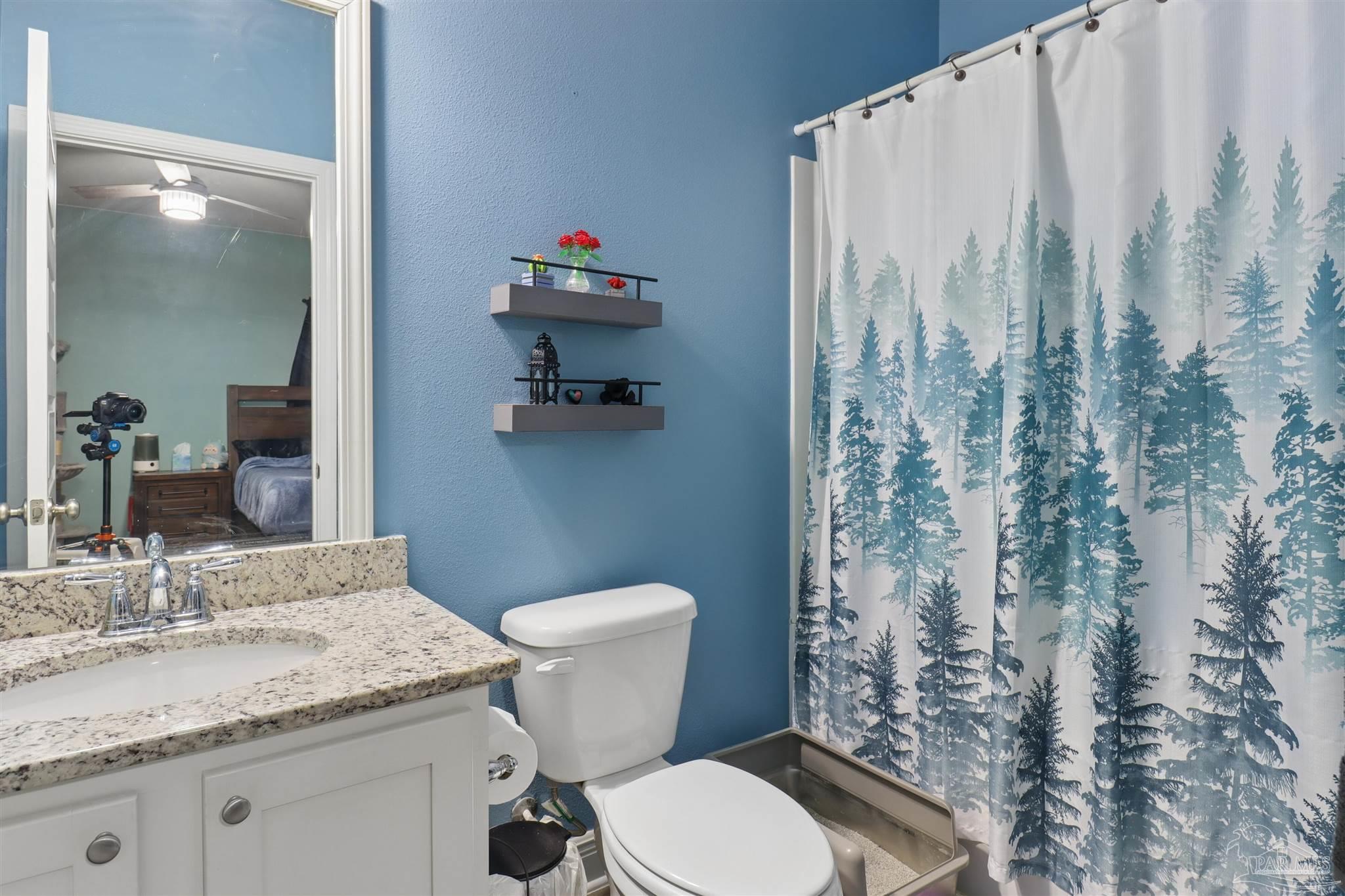 335 Cayden Way Cantonment, FL 32533 - Photo 13 of 30 a bathroom with a granite countertop sink toilet and shower