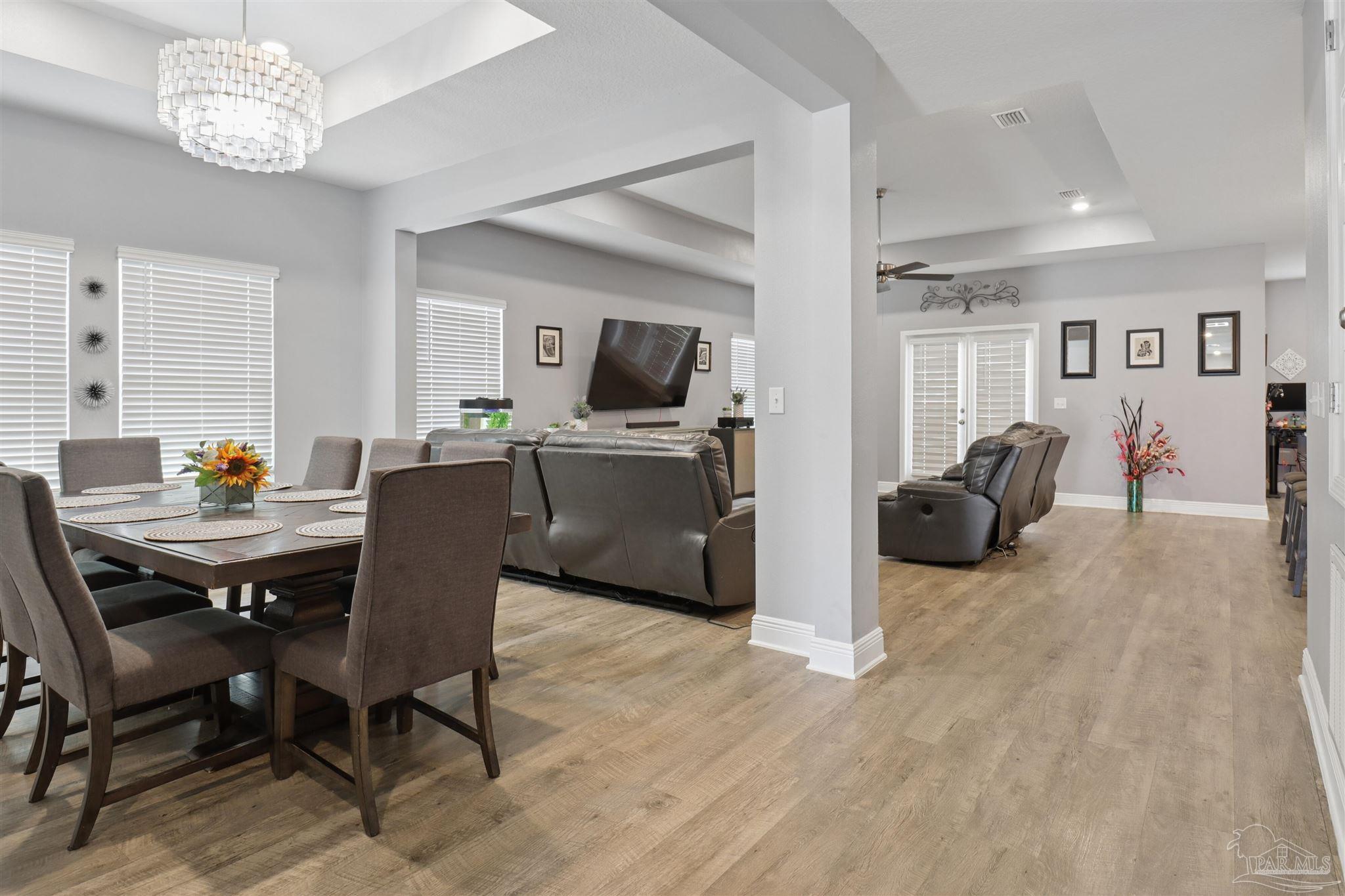 335 Cayden Way Cantonment, FL 32533 - Photo 14 of 30 a view of a dining room with furniture and chandelier
