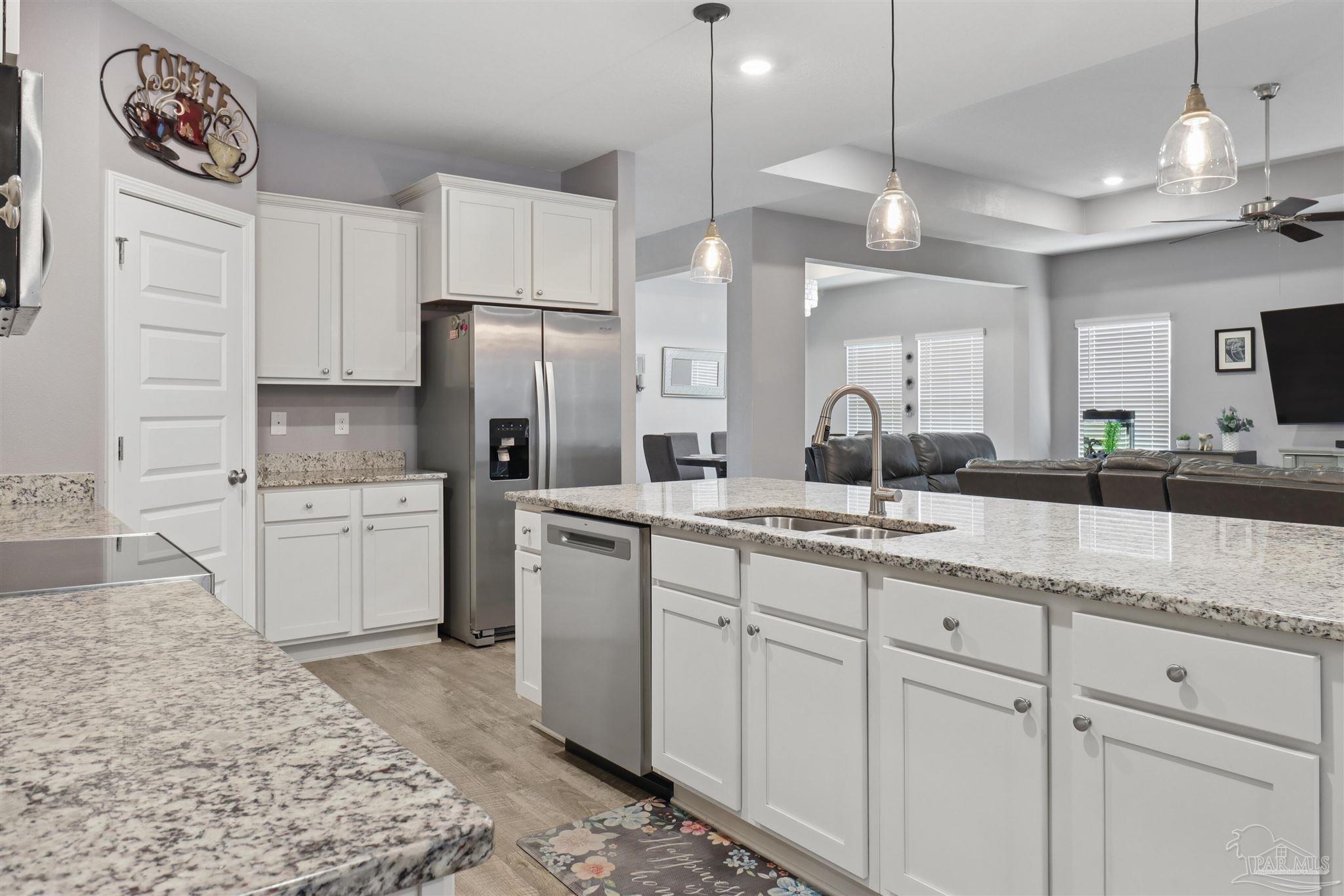 335 Cayden Way Cantonment, FL 32533 - Photo 19 of 30 a kitchen with white cabinets and appliances