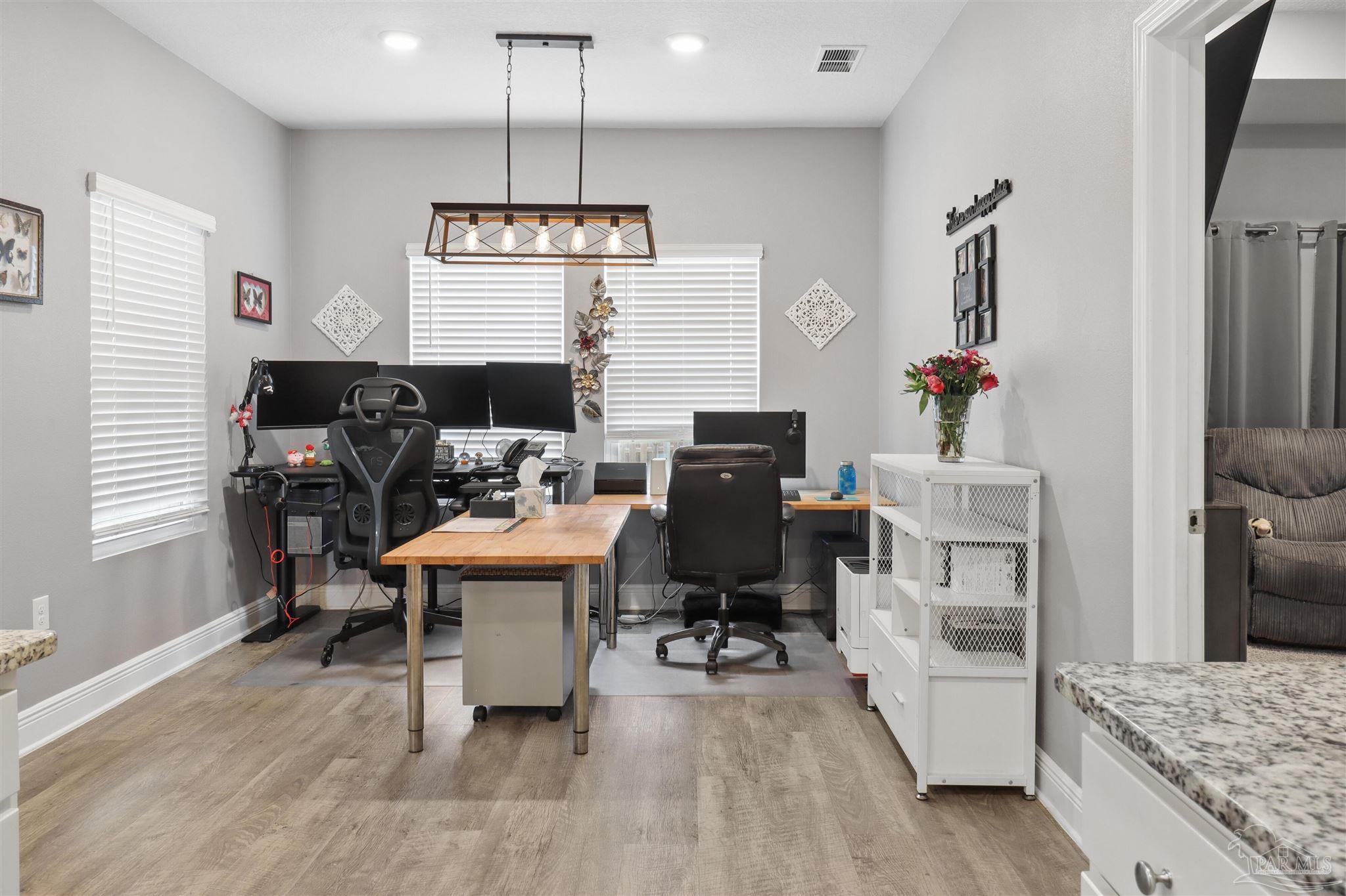 335 Cayden Way Cantonment, FL 32533 - Photo 20 of 30 a view of a kitchen area with furniture and wooden floor