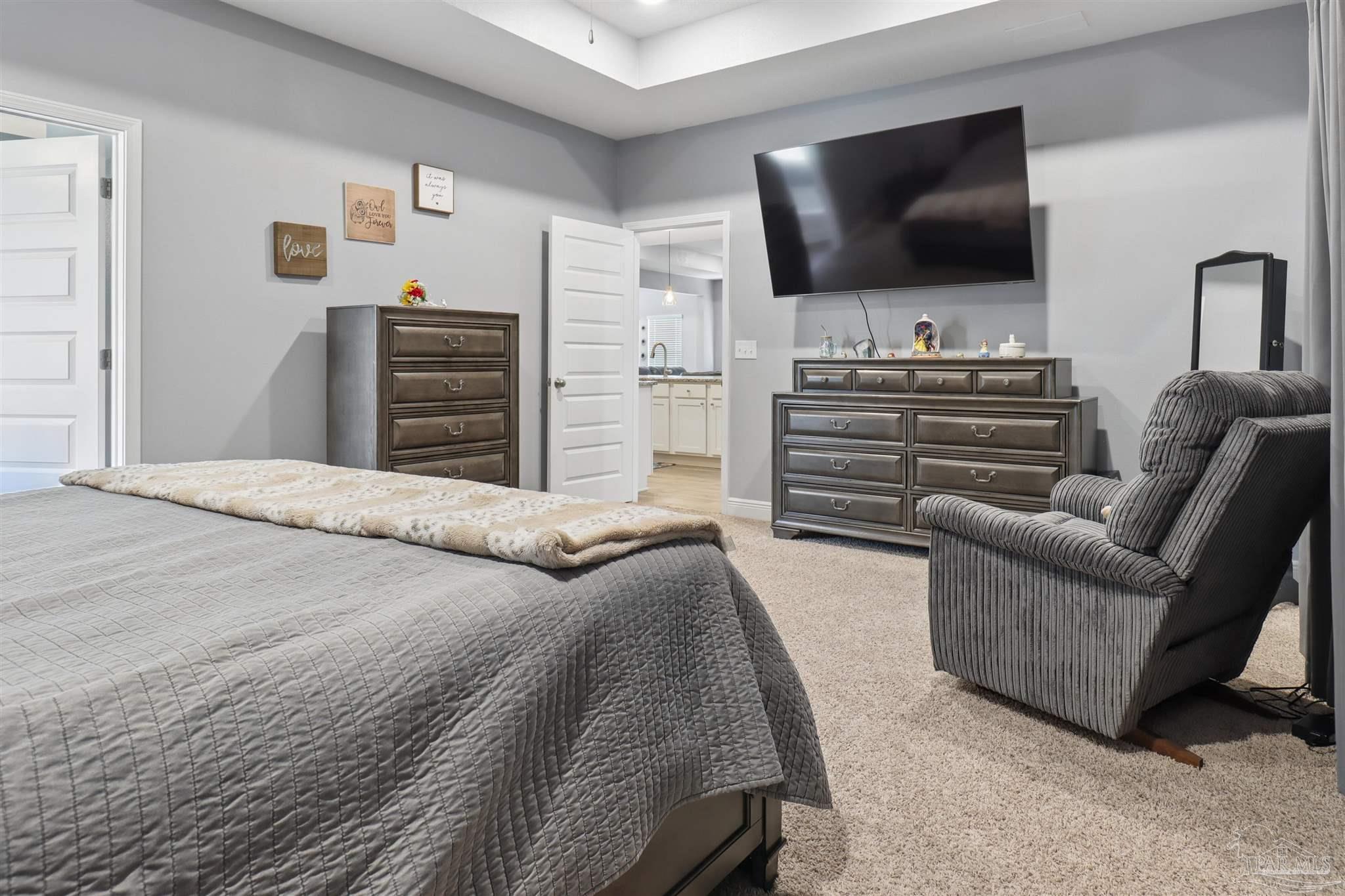335 Cayden Way Cantonment, FL 32533 - Photo 22 of 30 a bedroom with furniture and a flat screen tv
