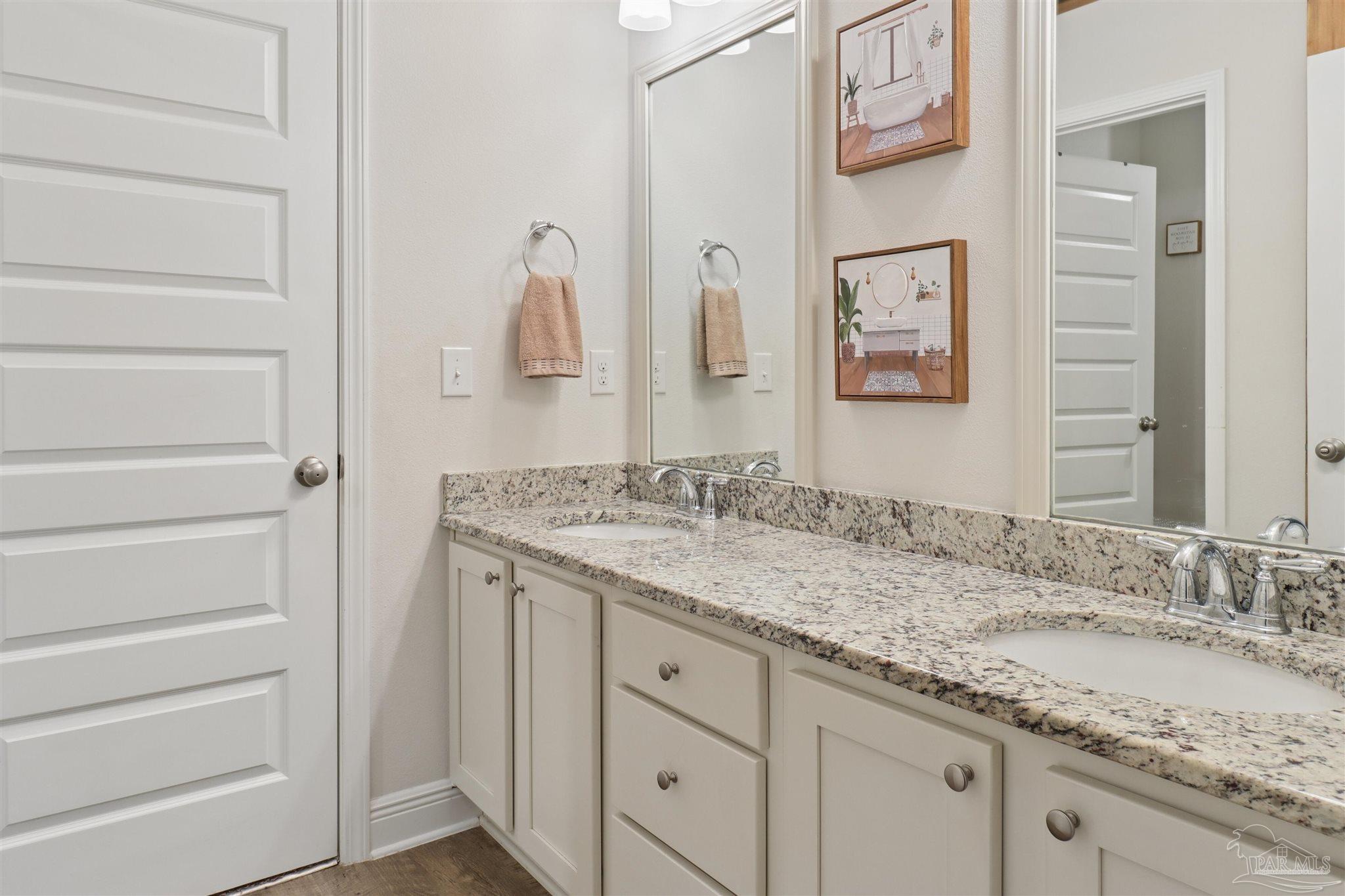 335 Cayden Way Cantonment, FL 32533 - Photo 3 of 30 a bathroom with a granite countertop sink and a mirror