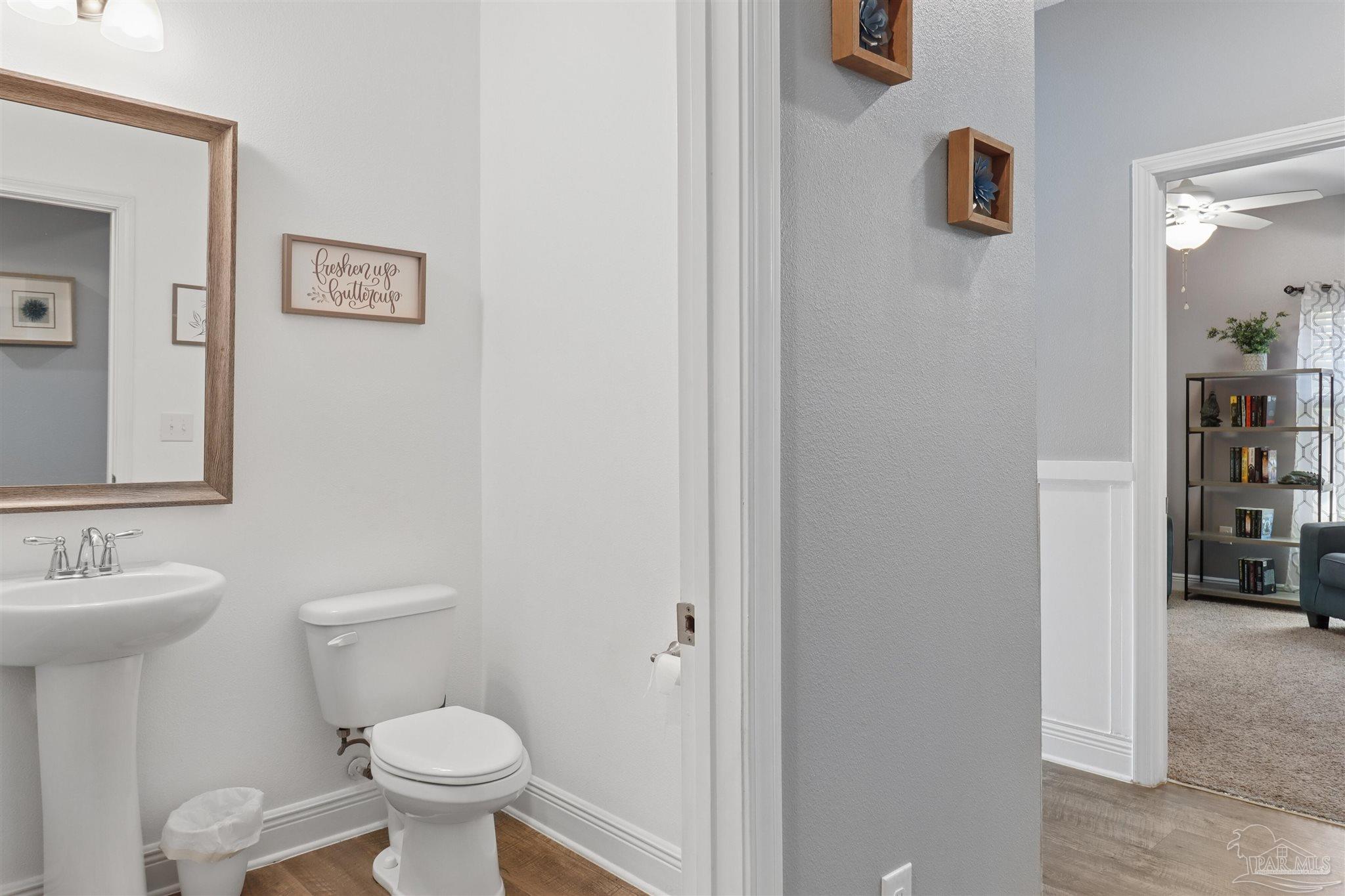 335 Cayden Way Cantonment, FL 32533 - Photo 7 of 30 a bathroom with a toilet sink and mirror