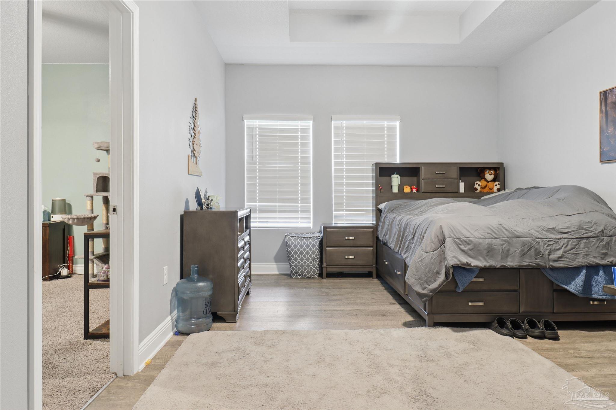335 Cayden Way Cantonment, FL 32533 - Photo 9 of 30 a bedroom with a bed and a chair