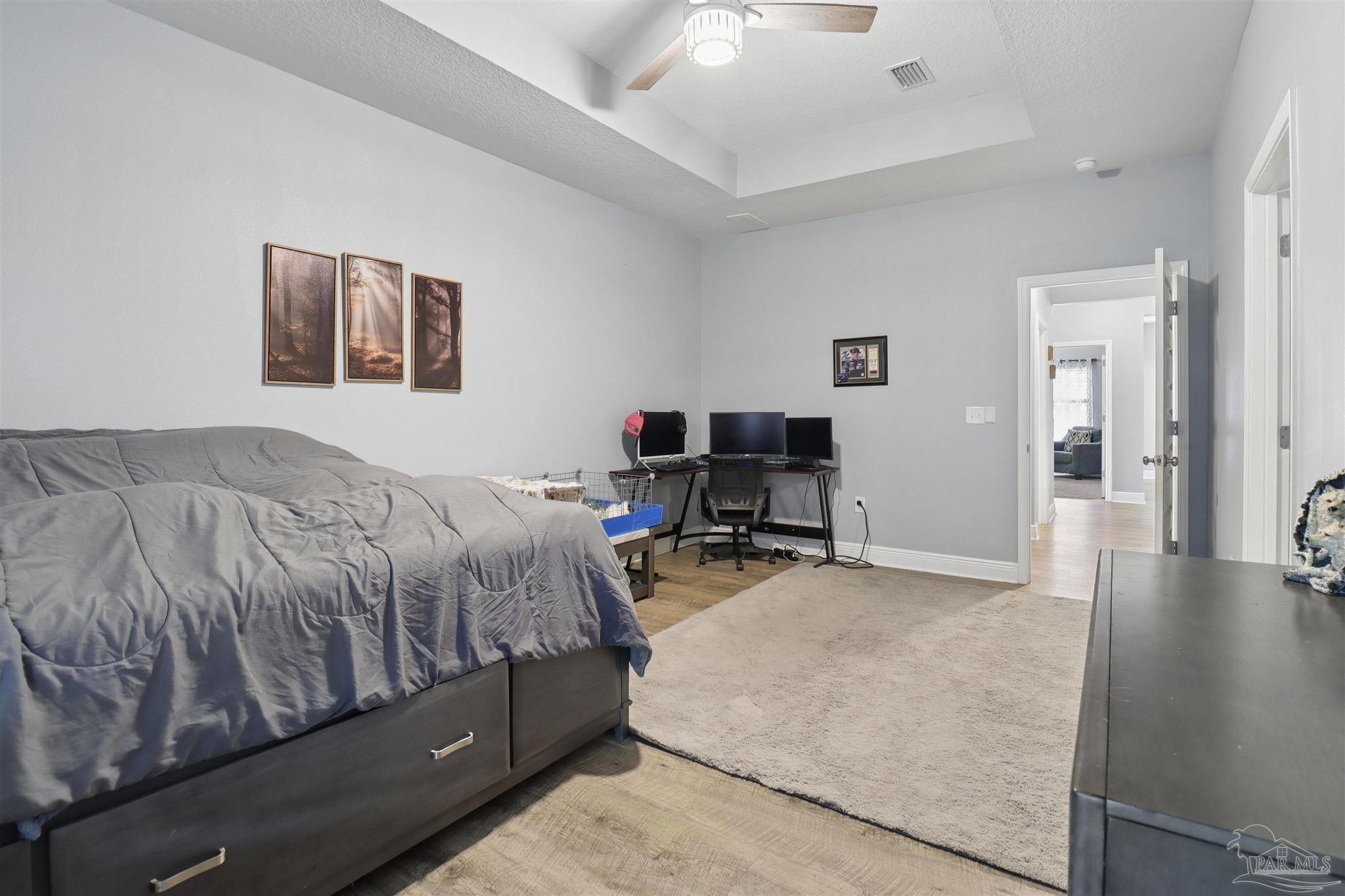 335 Cayden Way Cantonment, FL 32533 - Photo 10 of 30 a bedroom with a bed and furniture