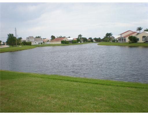 9727 Tavernier Drive Boca Raton, FL 33496 - Photo 16 of 16 a view of a lake with houses in the background