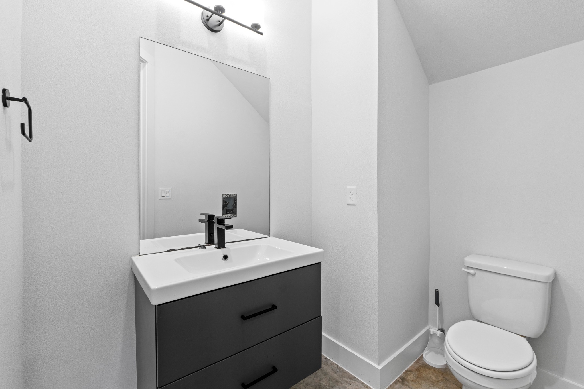 2007 Chestnut Avenue, Unit 1 Austin, TX 78722 - Photo 28 of 32 A well-appointed half bath features a modern vanity with integrated sink and sleek dark fixtures.