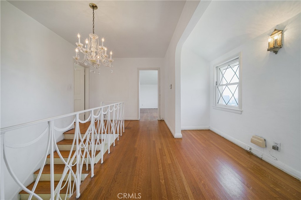 1625 Campbell Street Glendale, CA 91207 - Photo 14 of 19 a view of an empty room with chandelier fan and wooden floor