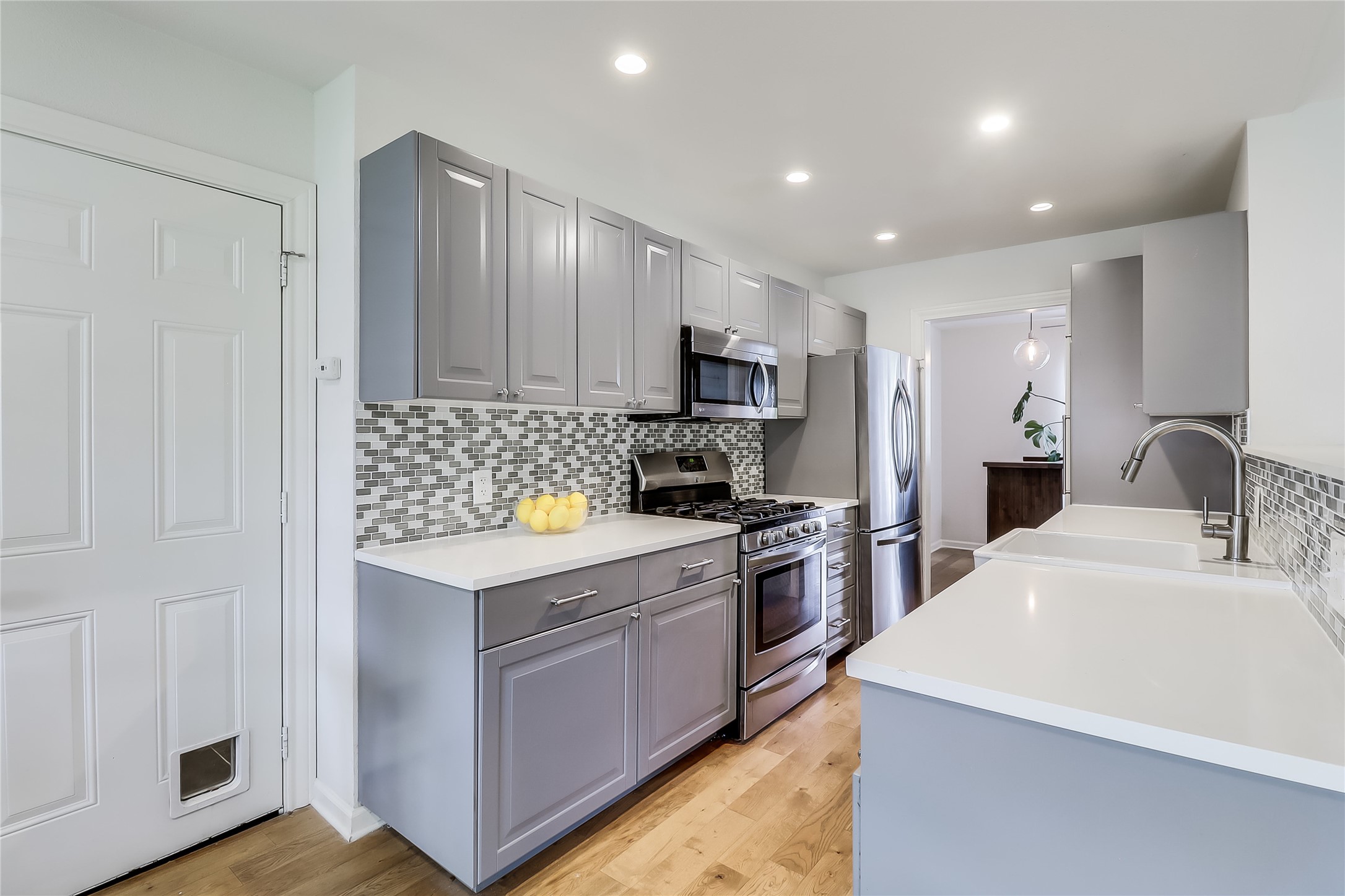 7300 Glenhill Road Austin, TX 78752 - Photo 12 of 37 a kitchen with a sink a stove a refrigerator cabinets and a window