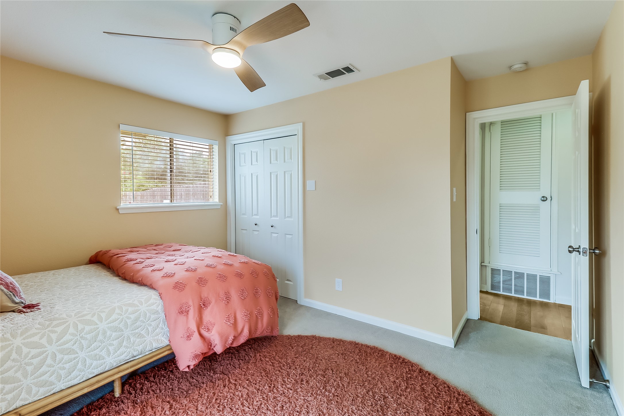 7300 Glenhill Road Austin, TX 78752 - Photo 23 of 37 a bedroom with a bed and a chandelier fan