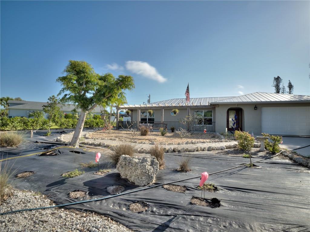 20621 Coconut Drive Estero, FL 33928 - Photo 2 of 37 a front view of a house with garden