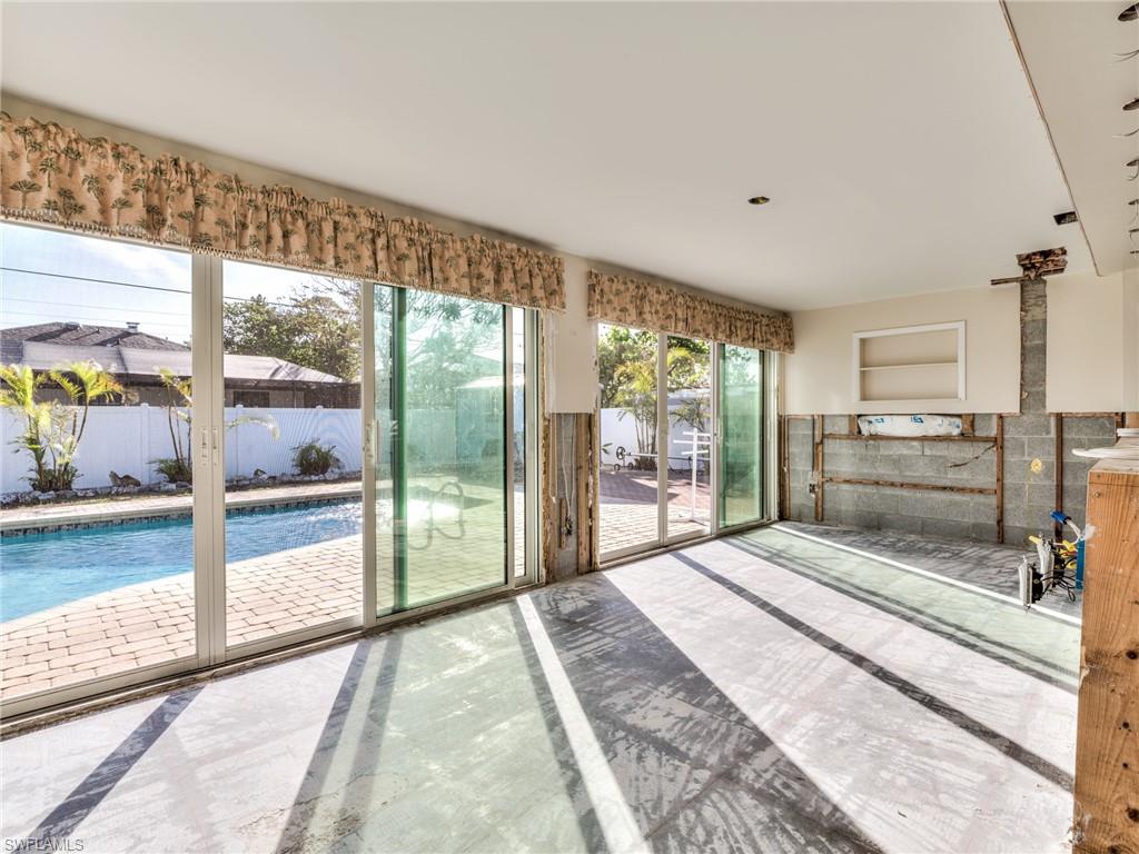 20621 Coconut Drive Estero, FL 33928 - Photo 22 of 37 a bedroom with a bed and large window with balcony view