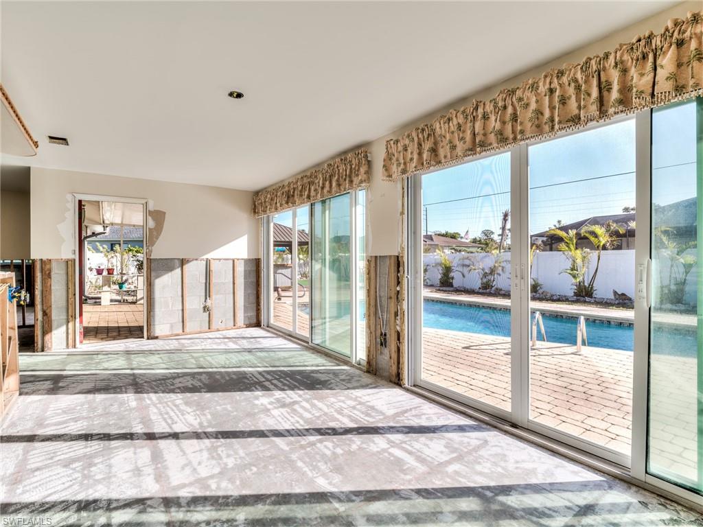 20621 Coconut Drive Estero, FL 33928 - Photo 25 of 37 a living room with a large window and a rug