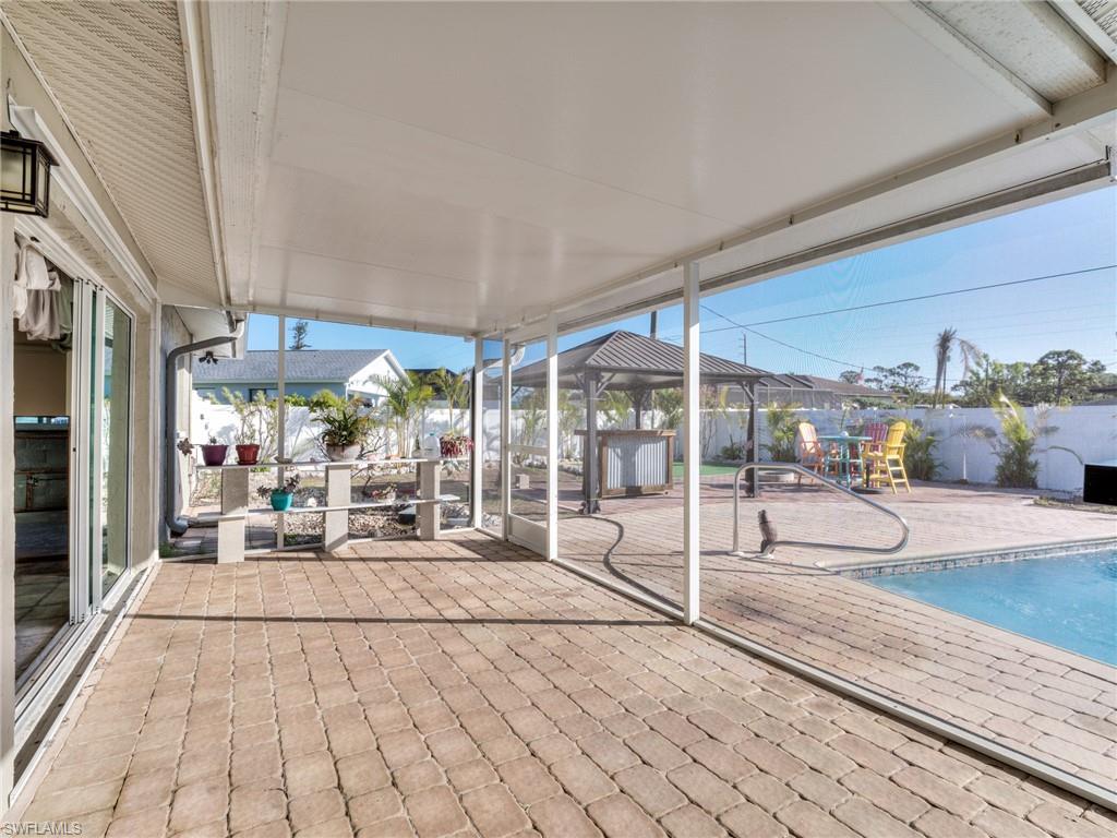 20621 Coconut Drive Estero, FL 33928 - Photo 28 of 37 a building outdoor space with patio furniture and potted plants
