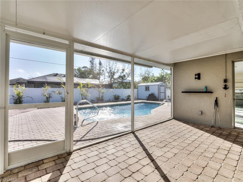 20621 Coconut Drive Estero, FL 33928 - Photo 29 of 37 a bedroom with a bed and large window with balcony view