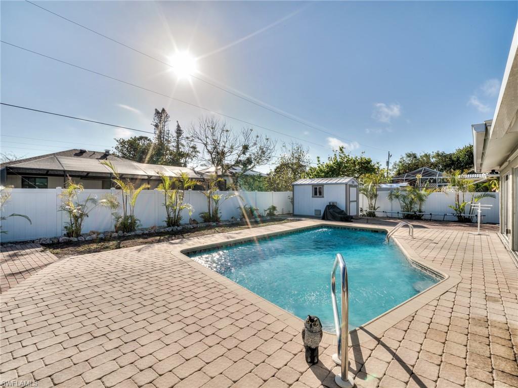 20621 Coconut Drive Estero, FL 33928 - Photo 30 of 37 a view of a swimming pool and lounge chair
