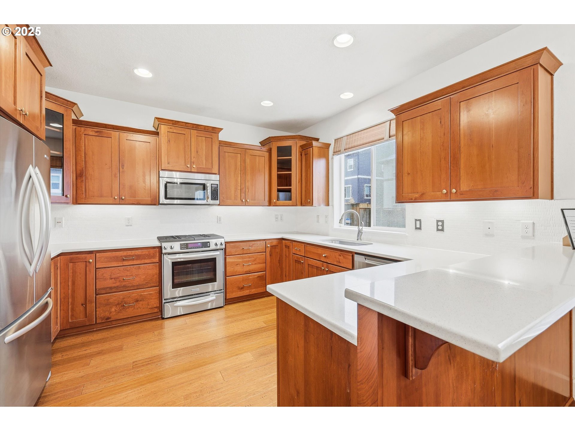 13765 Southwest Florentine Avenue Portland, OR 97223 - Photo 11 of 34 a kitchen with stainless steel appliances a sink stove and cabinets