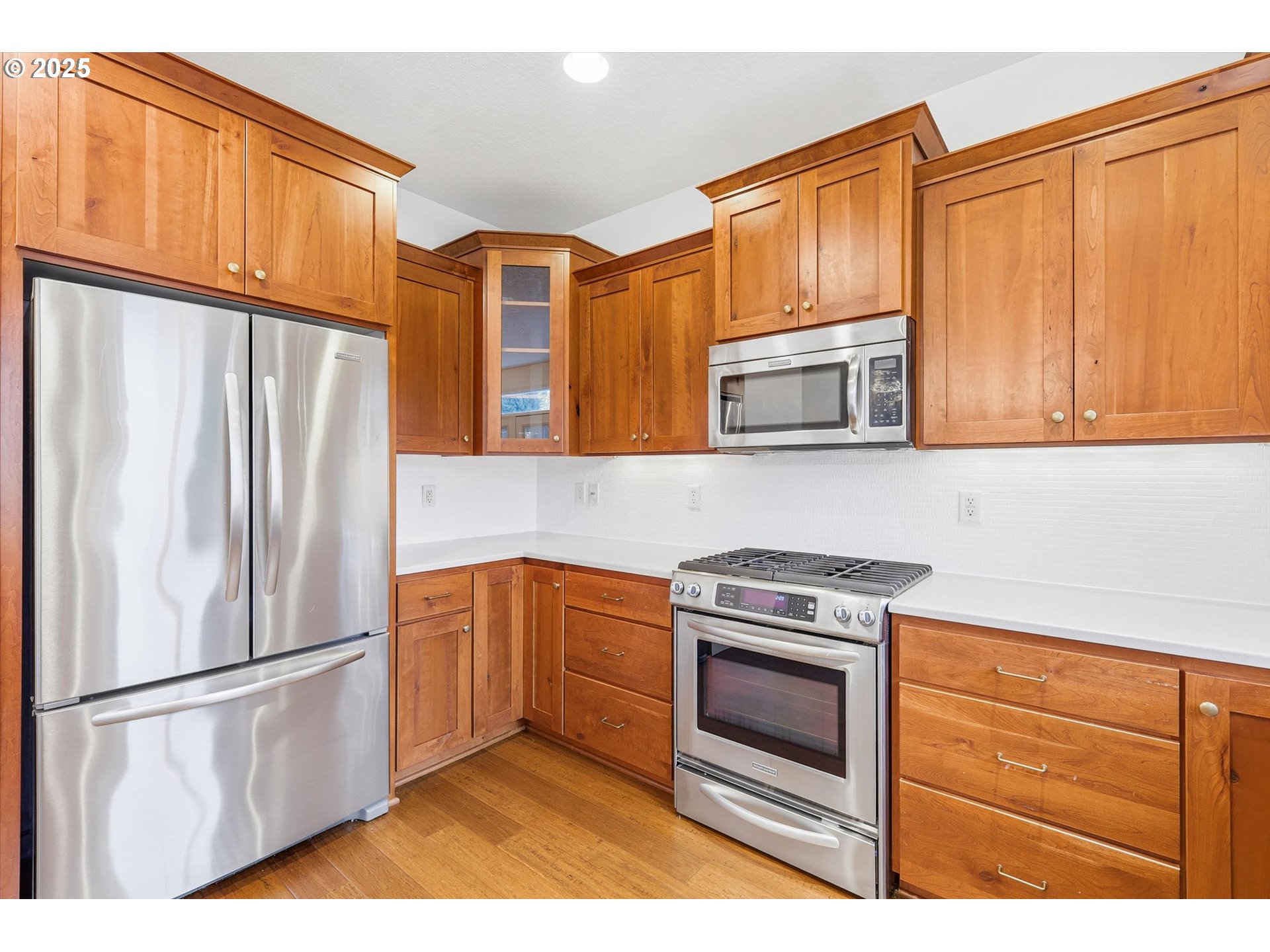 13765 Southwest Florentine Avenue Portland, OR 97223 - Photo 12 of 34 a kitchen with stainless steel appliances granite countertop a refrigerator stove and microwave