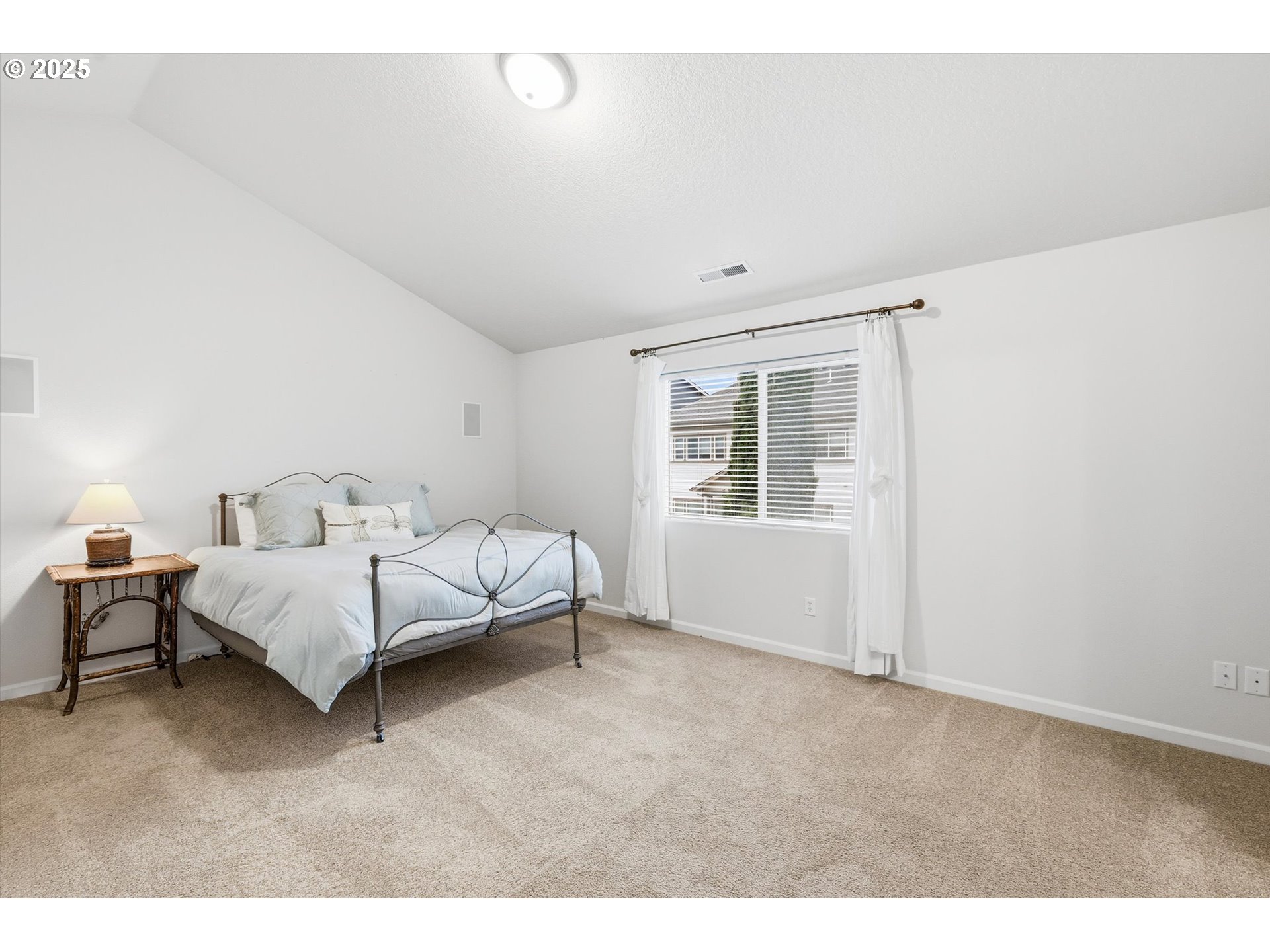13765 Southwest Florentine Avenue Portland, OR 97223 - Photo 19 of 34 a bed room with a bed and a window