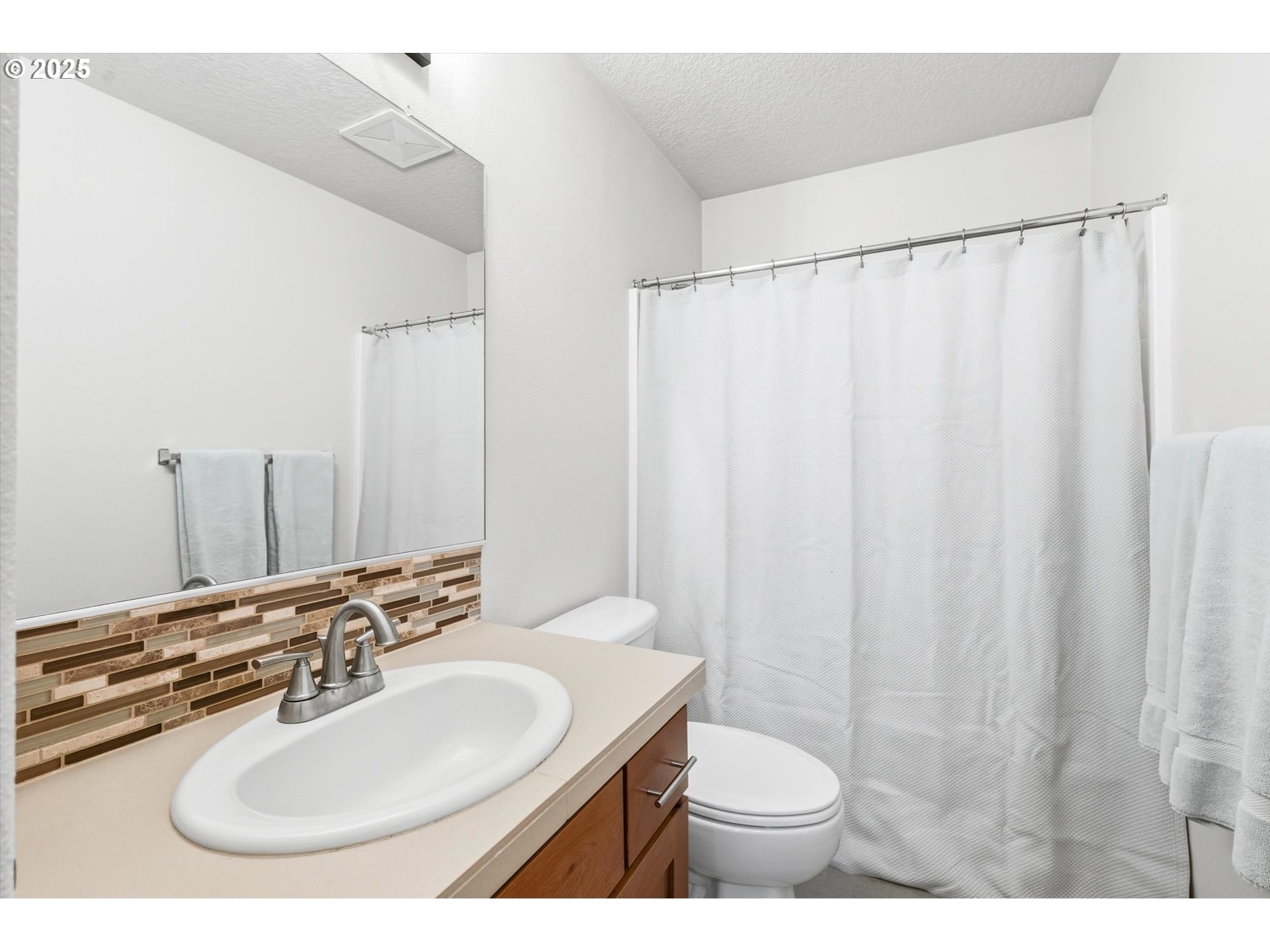 13765 Southwest Florentine Avenue Portland, OR 97223 - Photo 28 of 34 a bathroom with a sink and a mirror