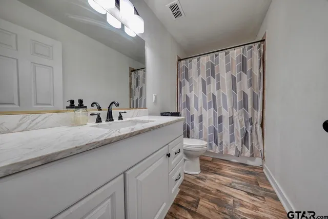 a bathroom with a double vanity sink and a mirror