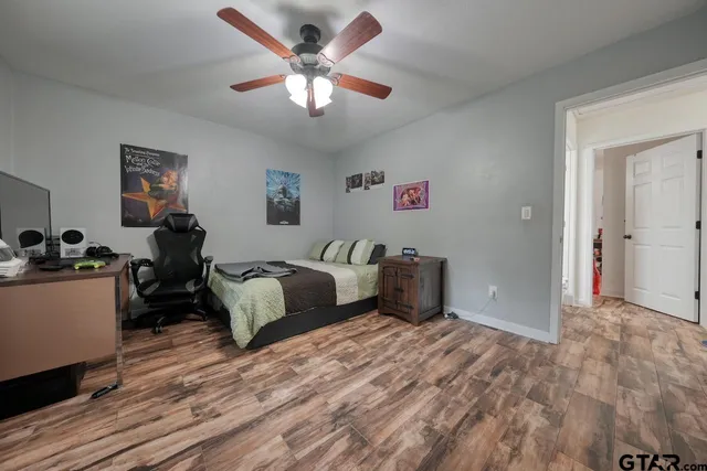 a view of a bedroom with workspace and a window