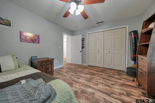 a kitchen with a dining table chairs and refrigerator