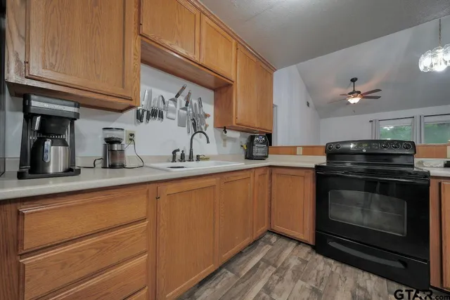 a kitchen with stainless steel appliances granite countertop a sink stove and cabinets