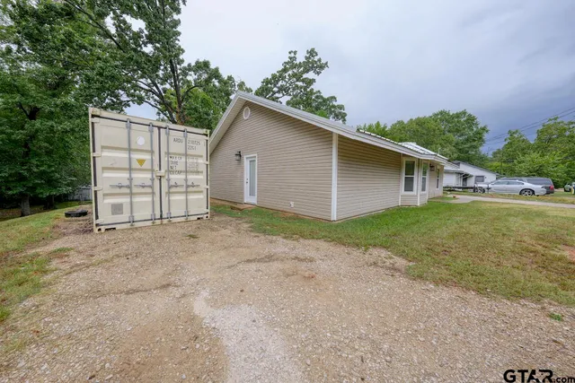 a view of a house with a yard and garage