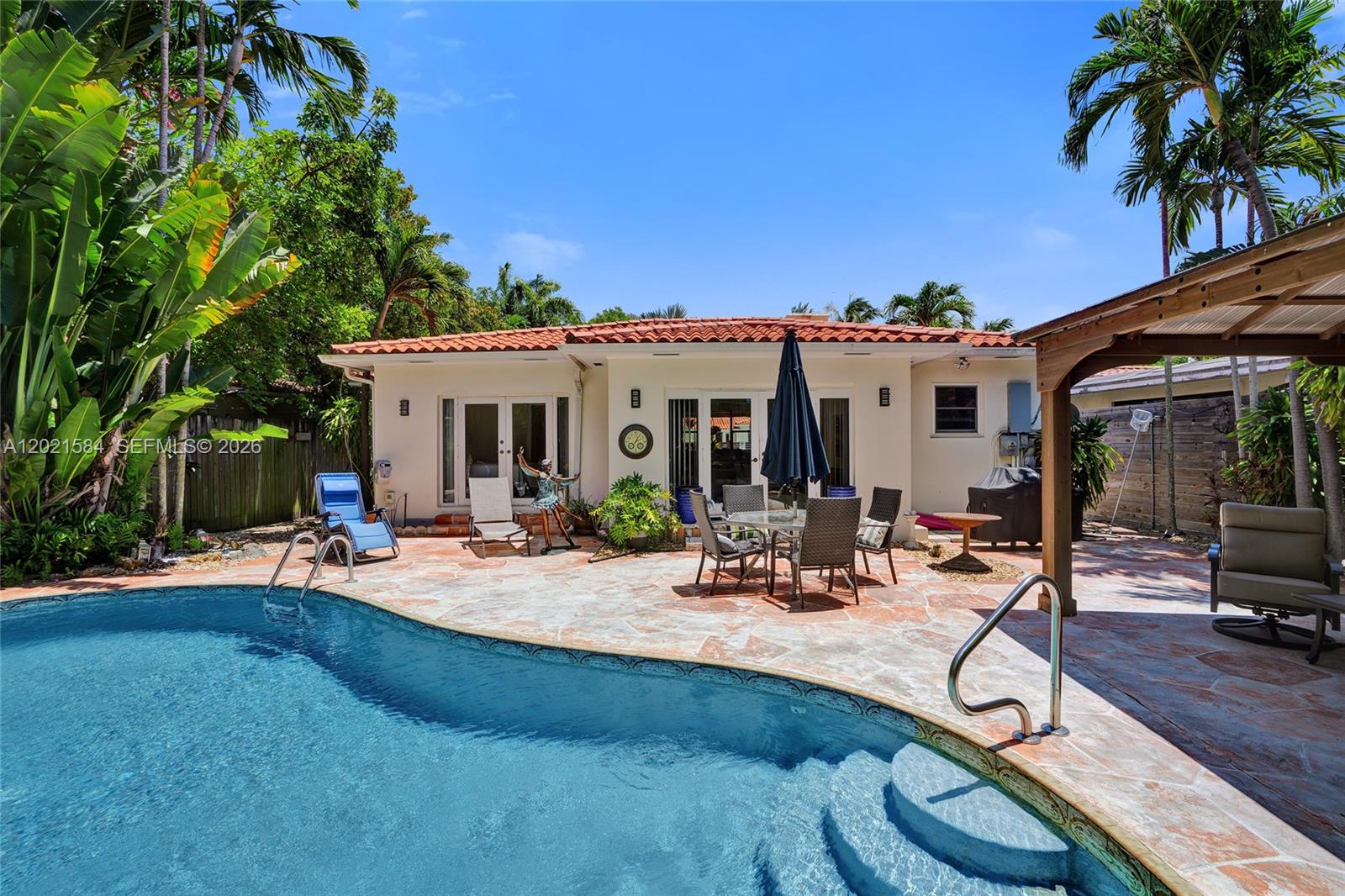 811 Northeast 73rd Street Miami, FL 33138 - Photo 20 of 51 a view of a house with patio porch and sitting area