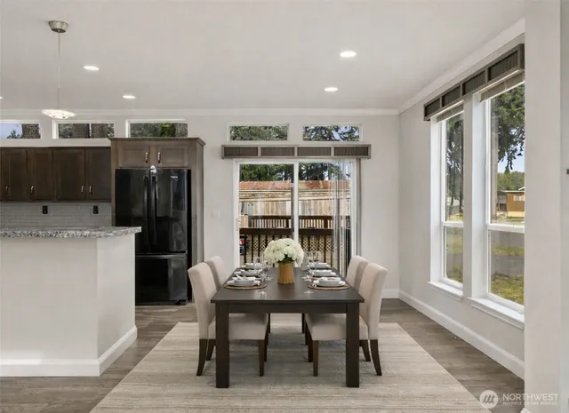 a view of a dining room with furniture and window