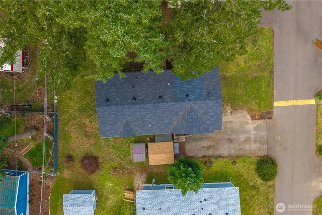 an aerial view of a house with a yard