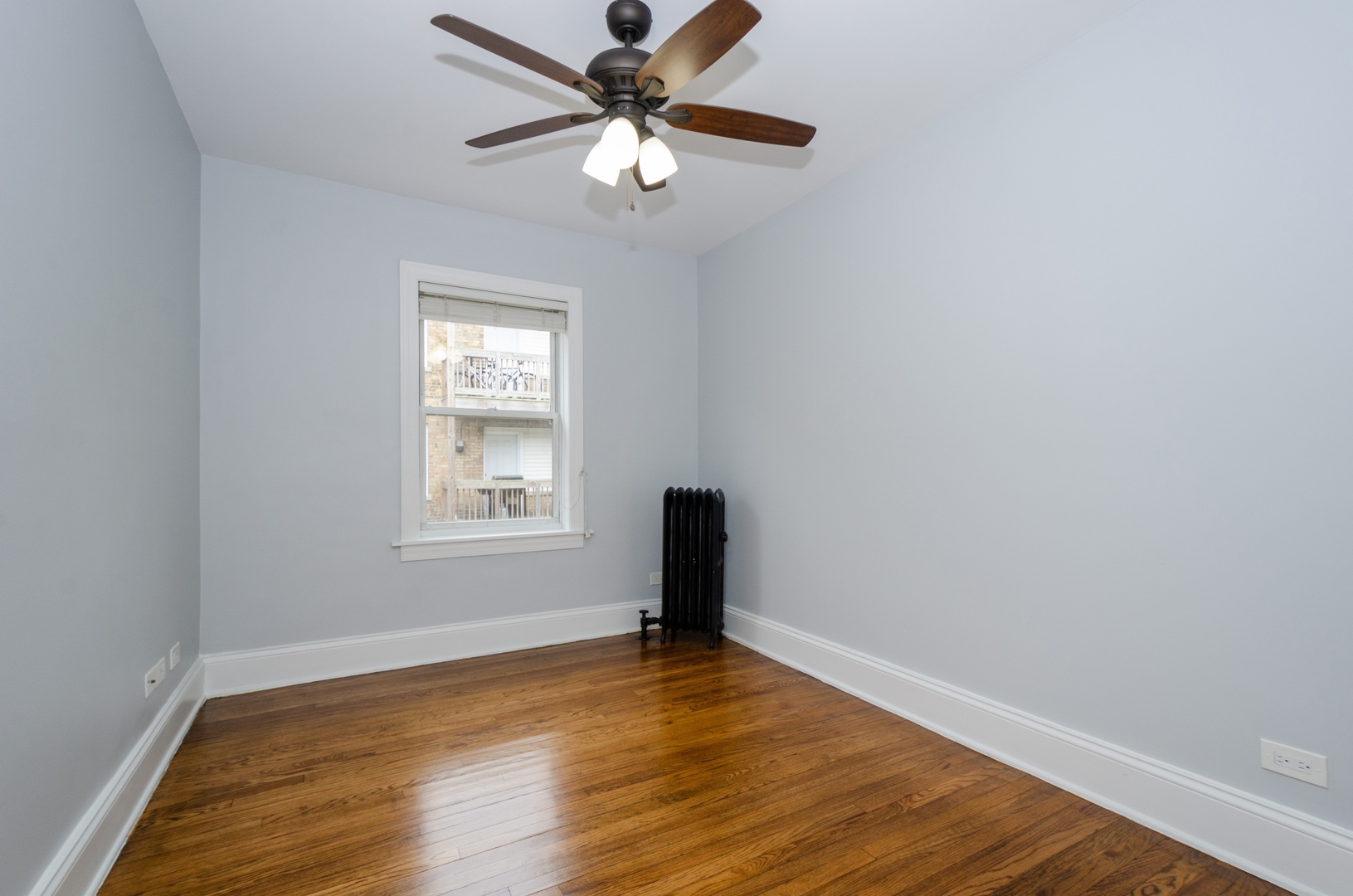 1609 West Juneway Terrace, Unit 1D Chicago, IL 60626 - Photo 6 of 8 a view of a room with wooden floor and a ceiling fan