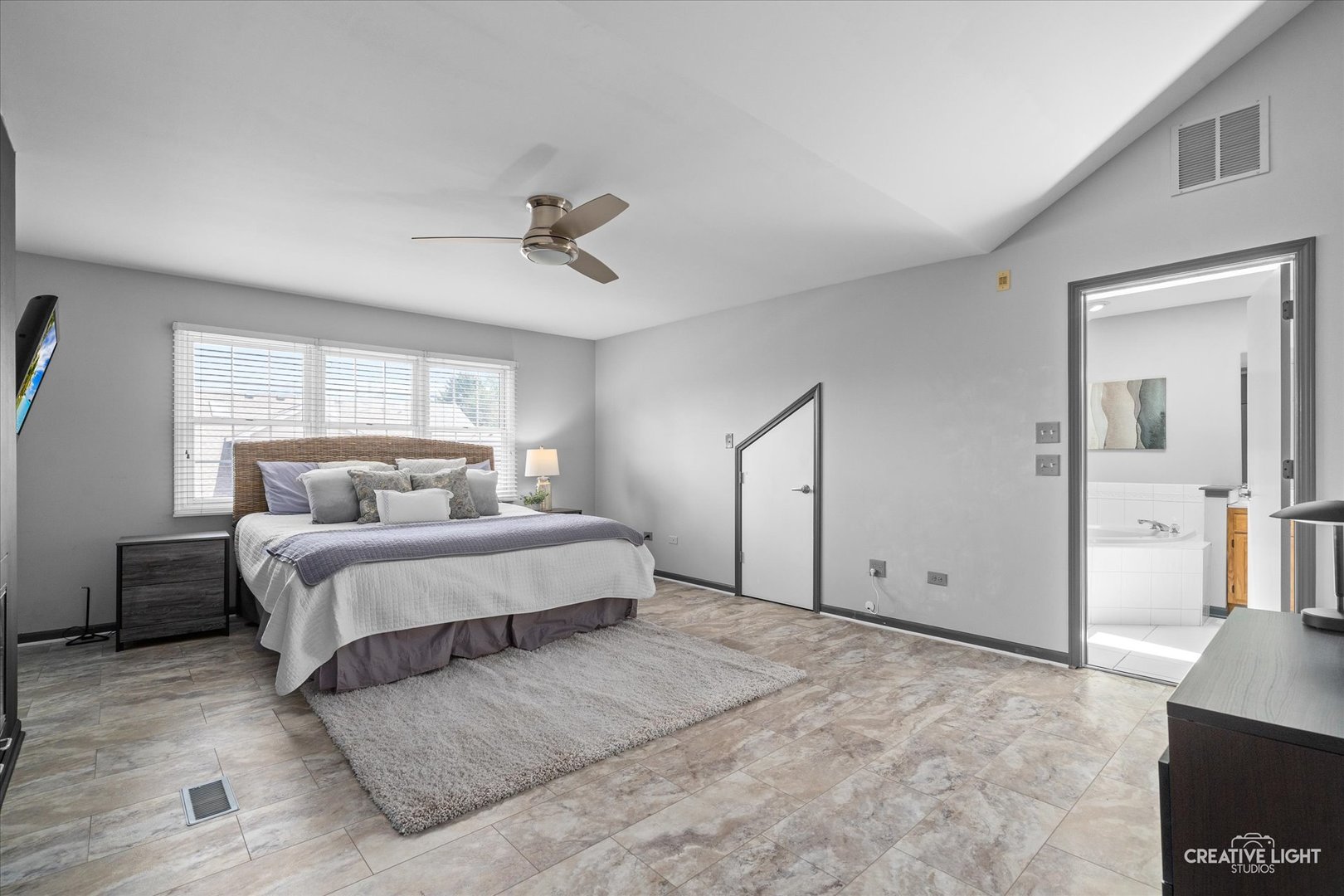 838 Havenshire Road Naperville, IL 60565 - Photo 29 of 48 a spacious bedroom with a large bed and a chandelier