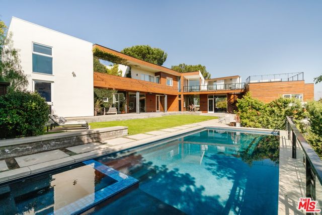 a view of swimming pool with outdoor seating and plants